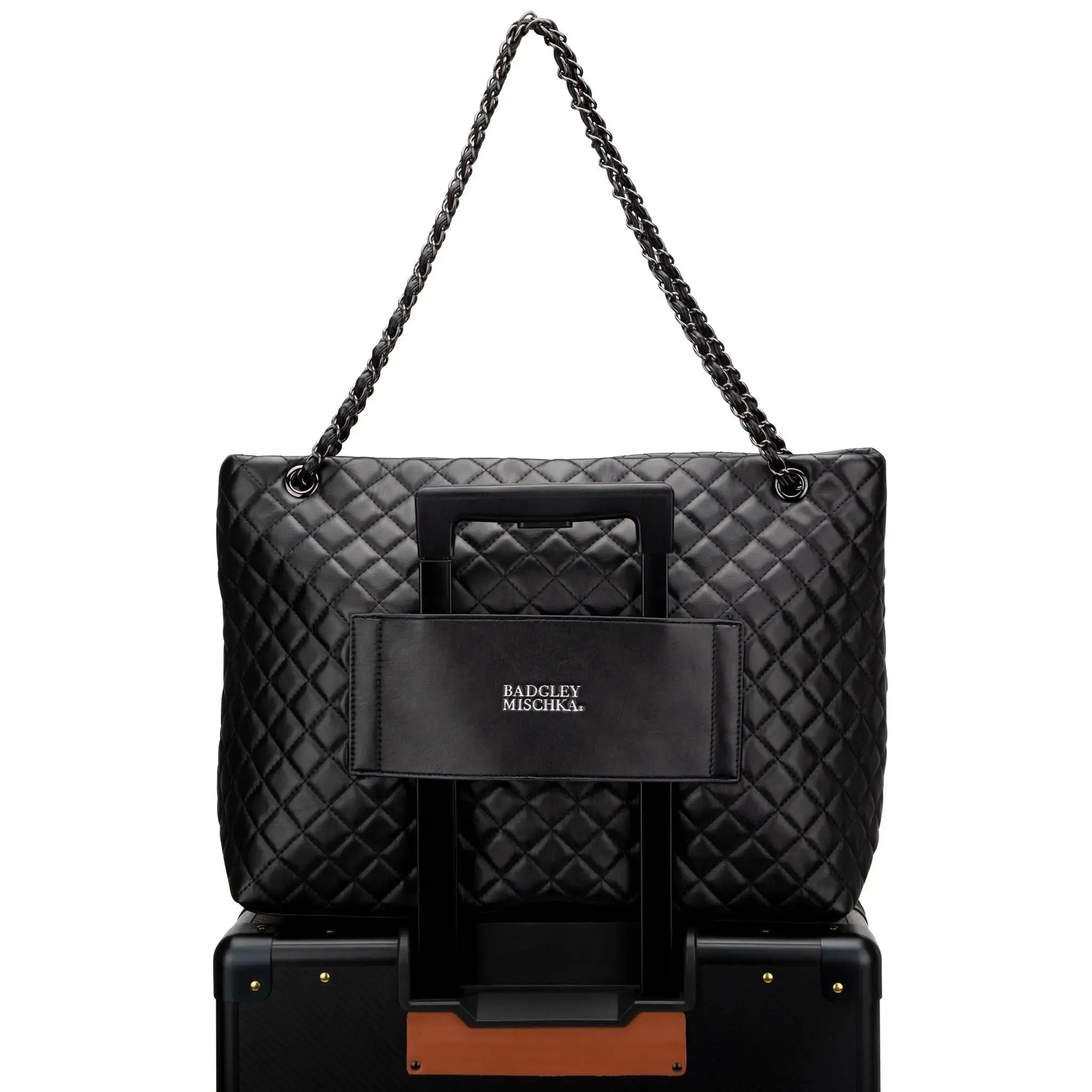 Black quilted handbag with chain strap on a white background