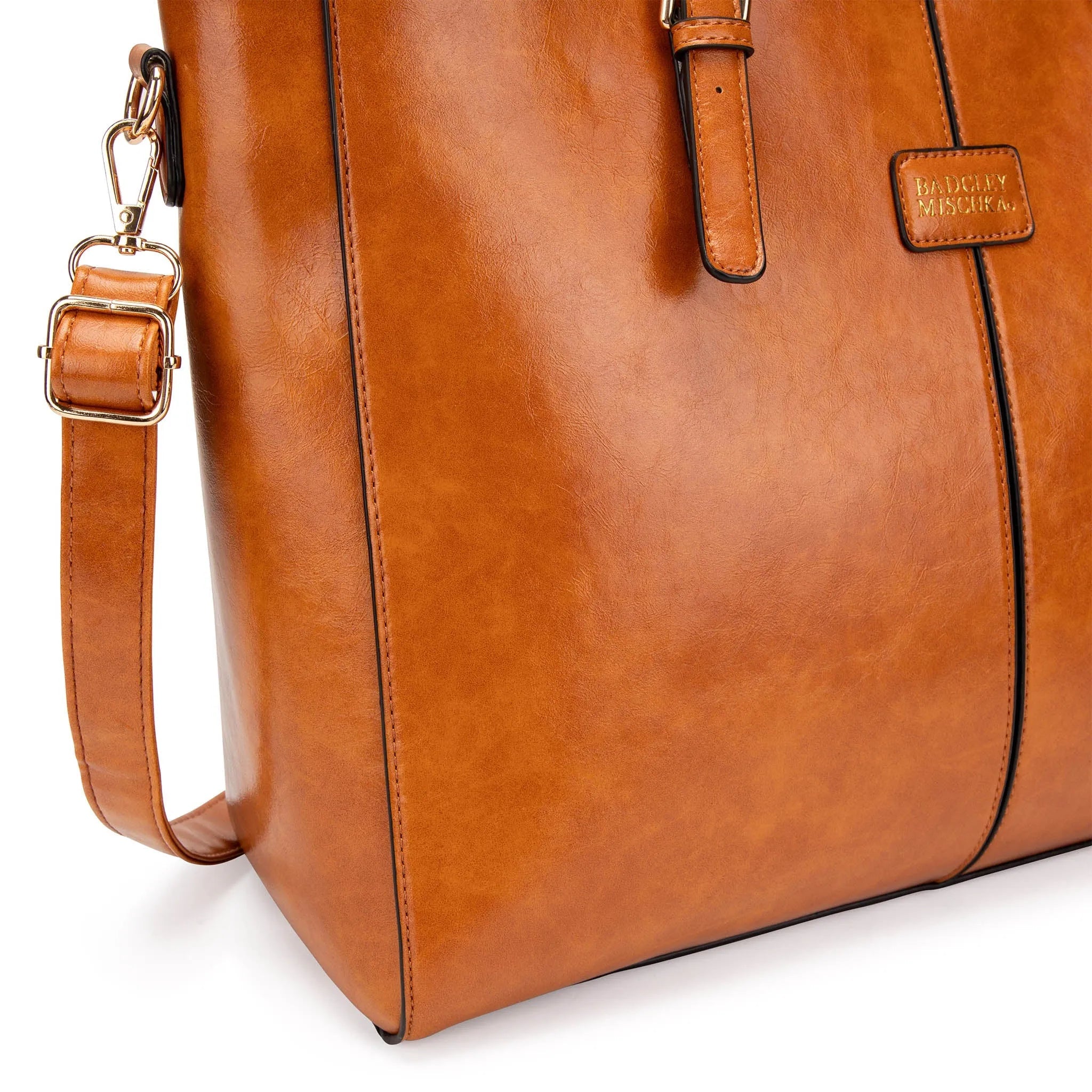 Brown leather bag with strap on a white background