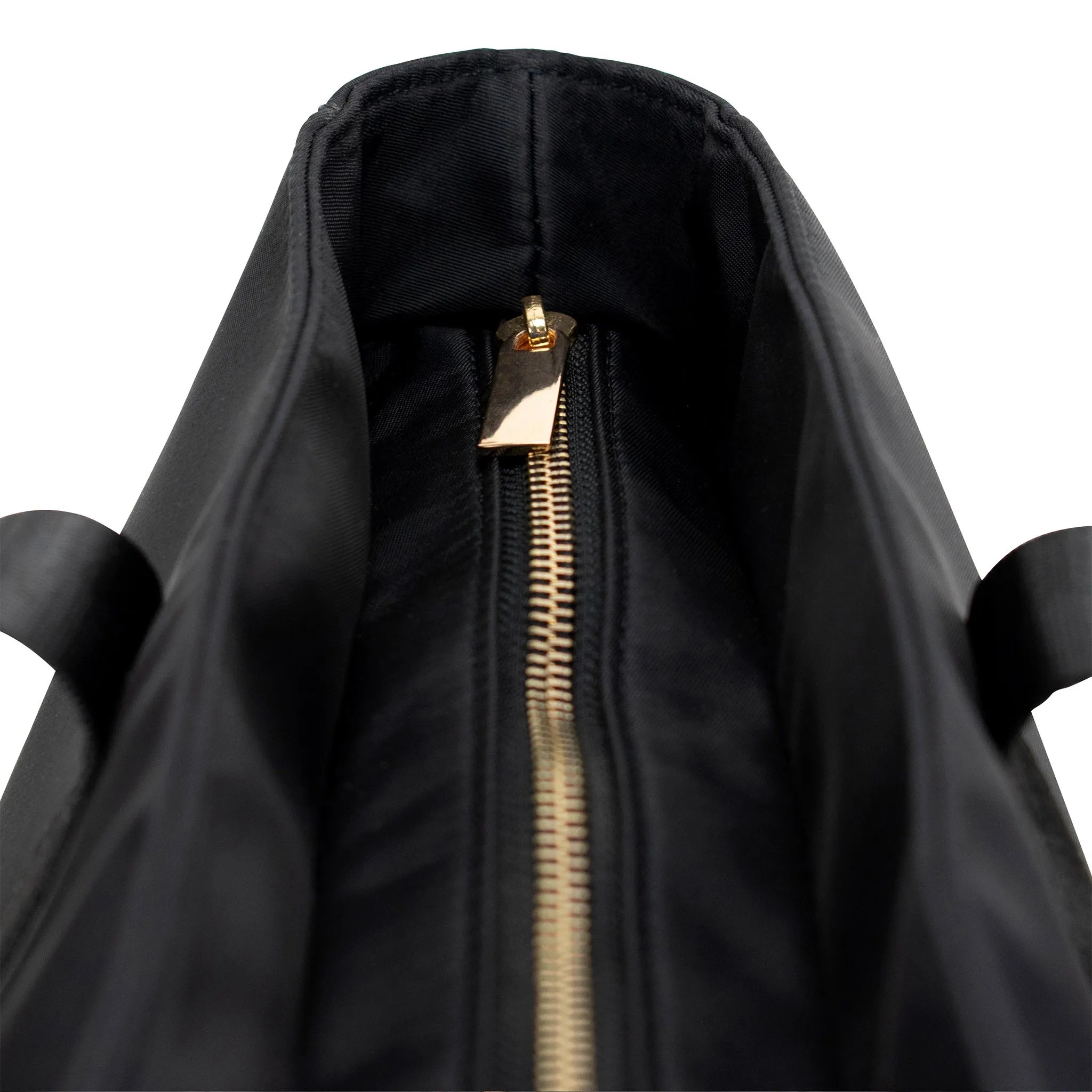 Close-up of a black bag with a gold zipper on a white background