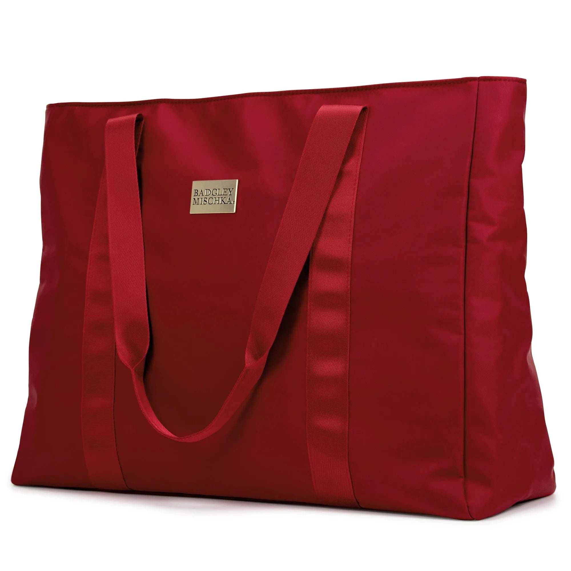 A black nylon tote bag with a shiny gold logo plate, soft webbing straps, and a zippered rear pocket. The bag is displayed in a way that showcases its spacious design and sleek finish.