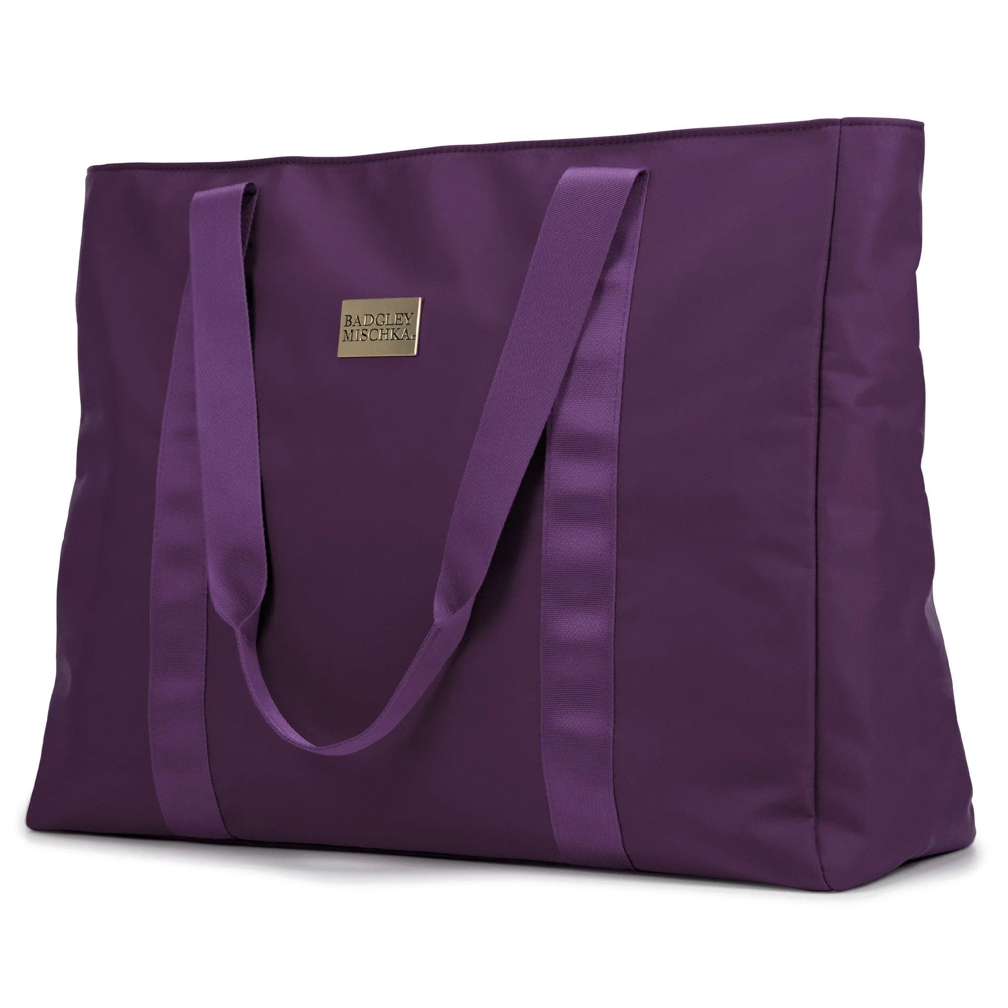A black nylon tote bag with a shiny gold logo plate, soft webbing straps, and a zippered rear pocket. The bag is displayed in a way that showcases its spacious design and sleek finish.