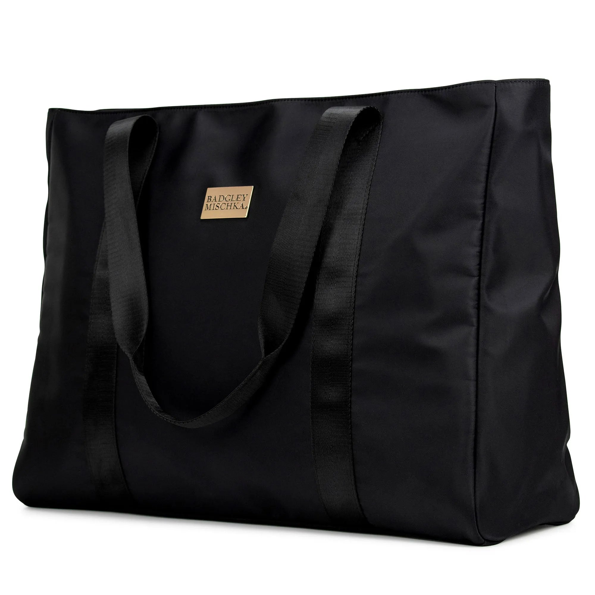 A black nylon tote bag with a shiny gold logo plate, soft webbing straps, and a zippered rear pocket. The bag is displayed in a way that showcases its spacious design and sleek finish.