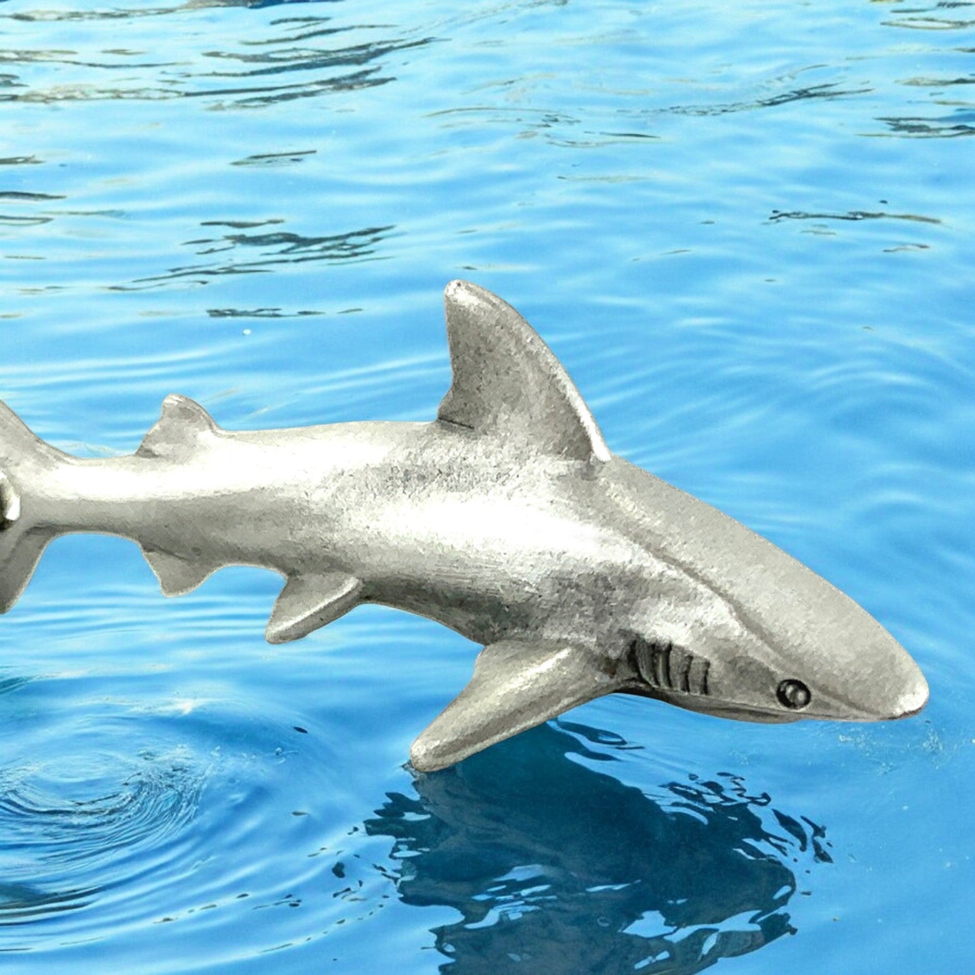 Shark figurine on a blue water background