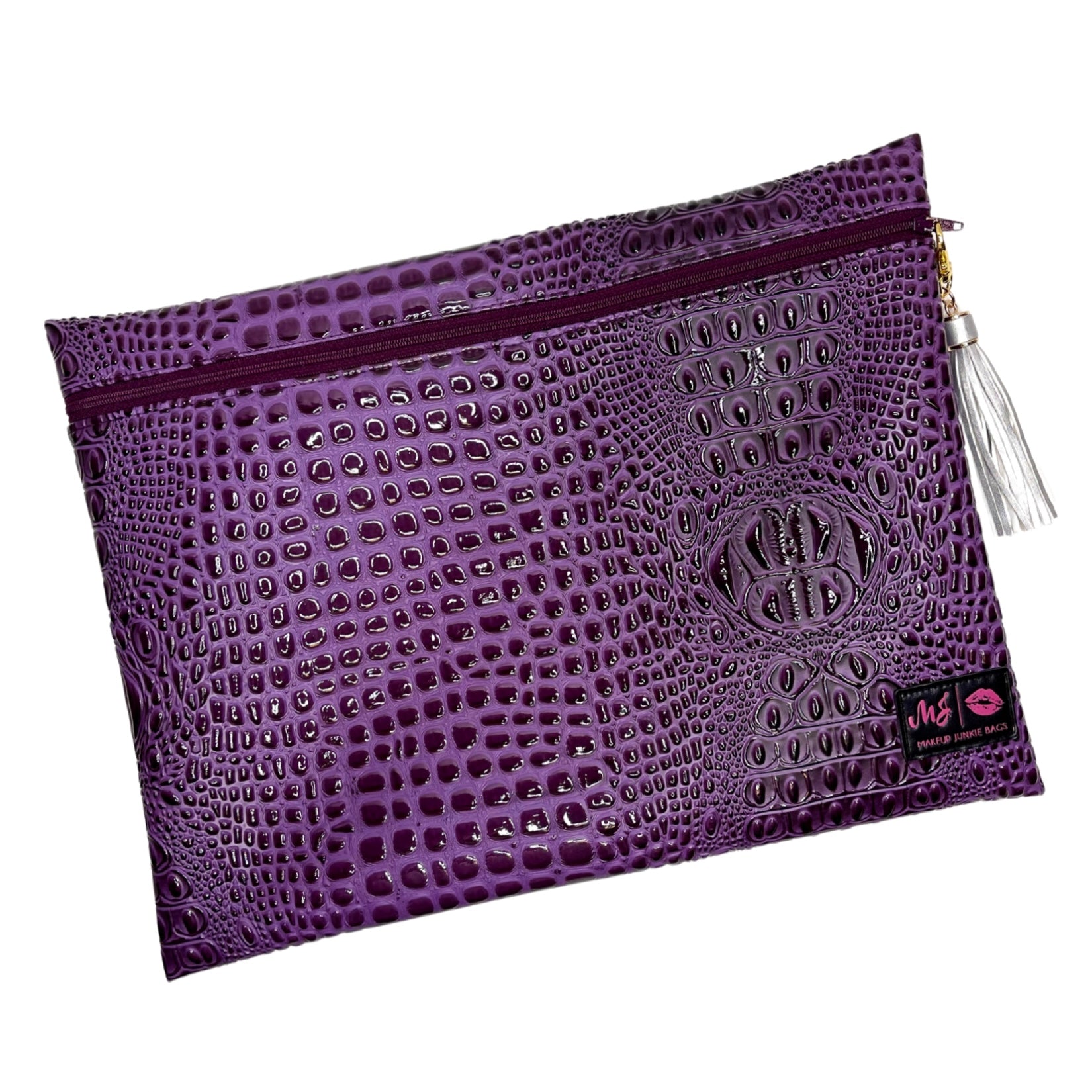 Purple textured pouch with a tassel on a white background