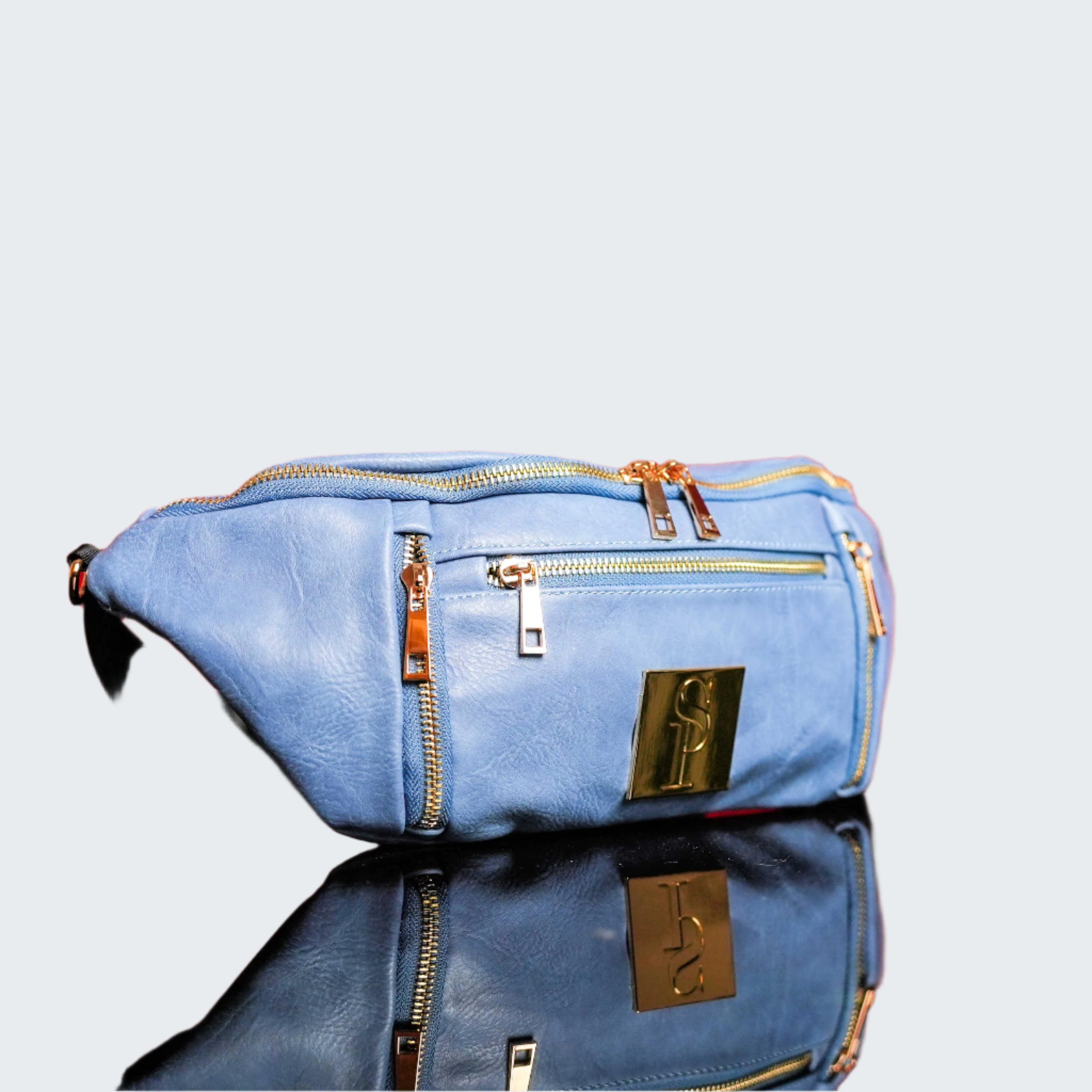 Blue bag with gold accents on a red reflective surface