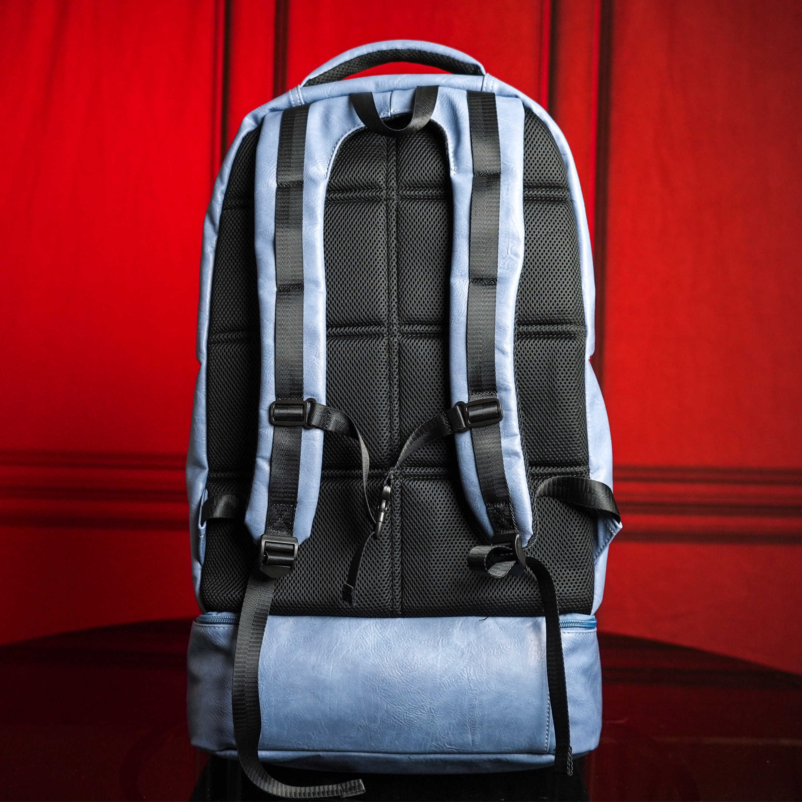 Blue and black backpack on a red background
