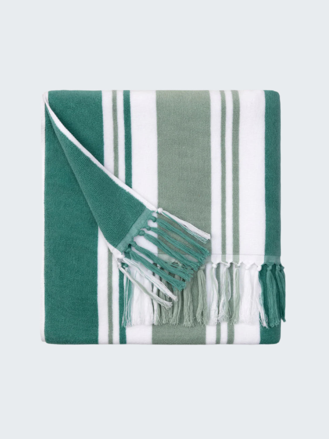 Green and white striped towel with fringes on a white background