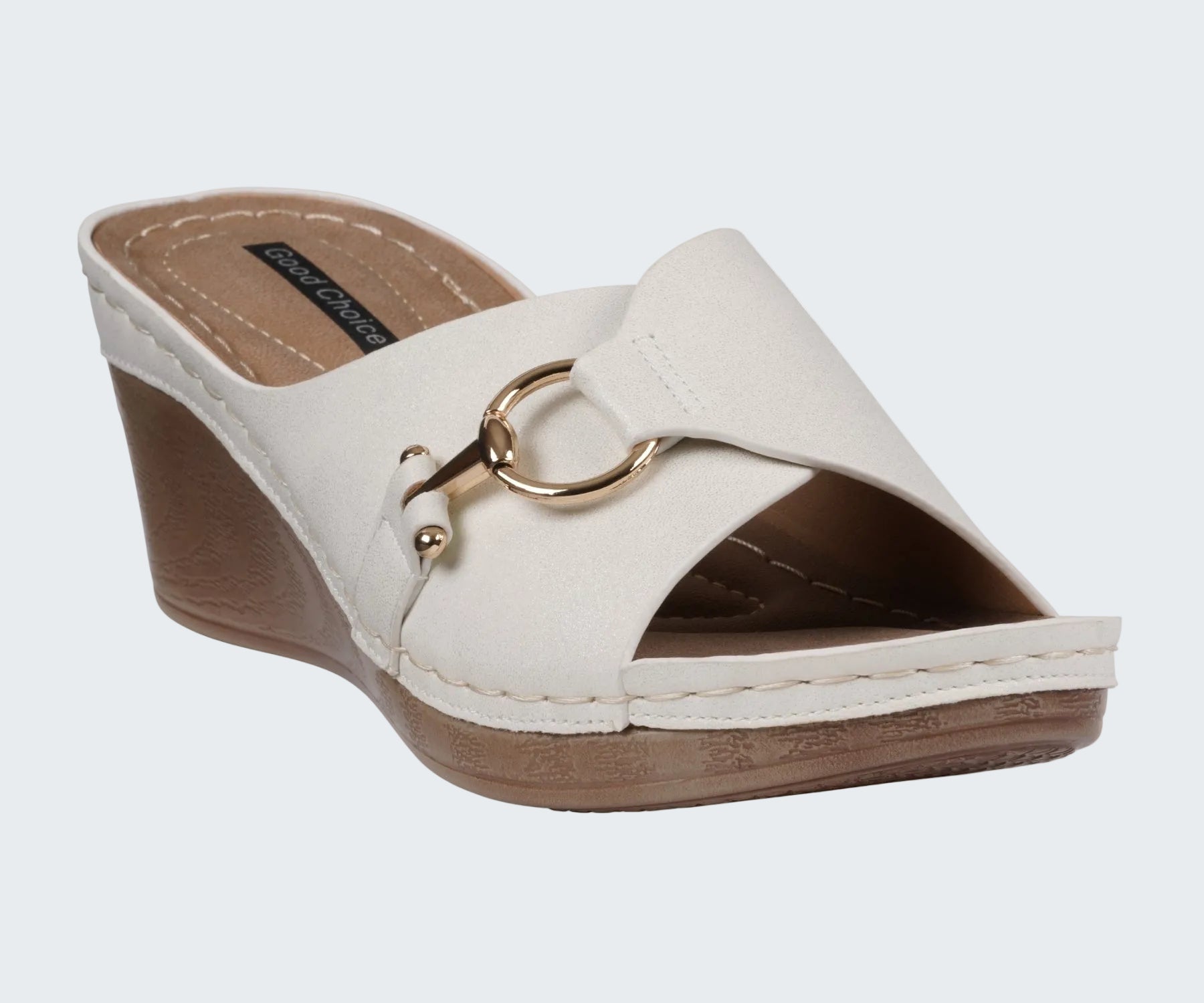 White wedge sandal with gold buckle on a white background