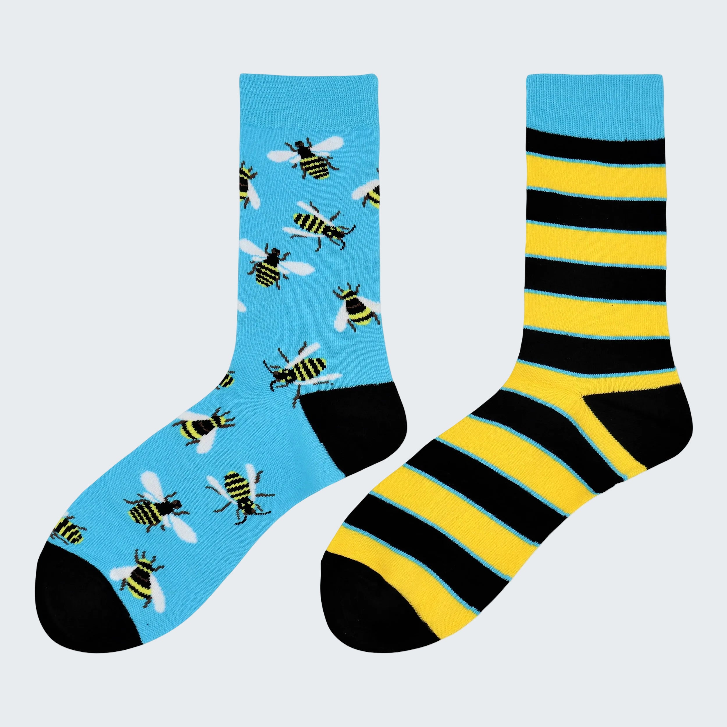 Two socks with bee pattern and striped design on a white background
