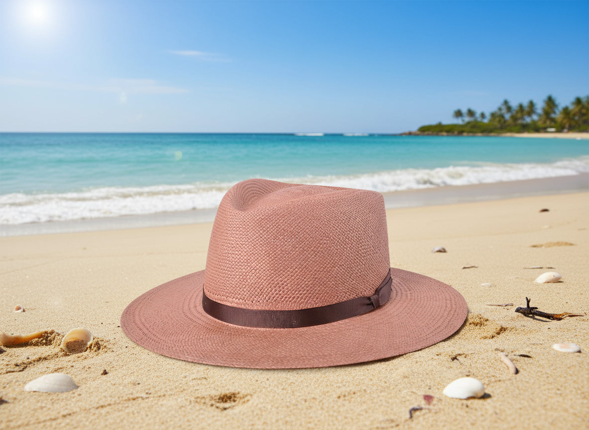 Pink straw hat with a brown band on a white background