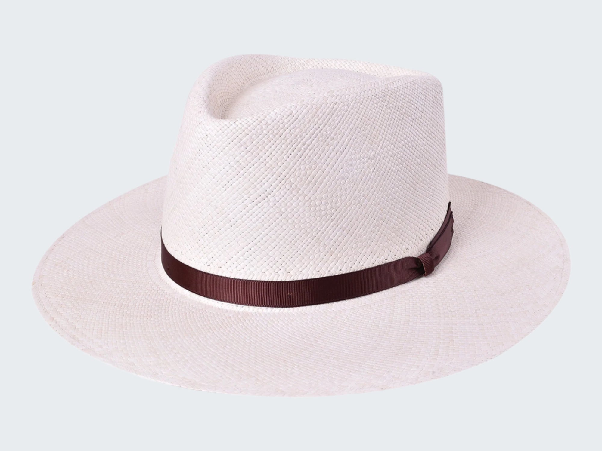White straw hat with a brown band on a white background