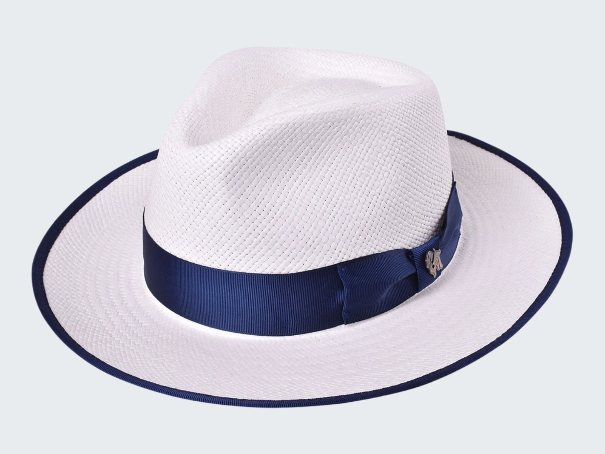 White straw hat with a navy blue band on a white background