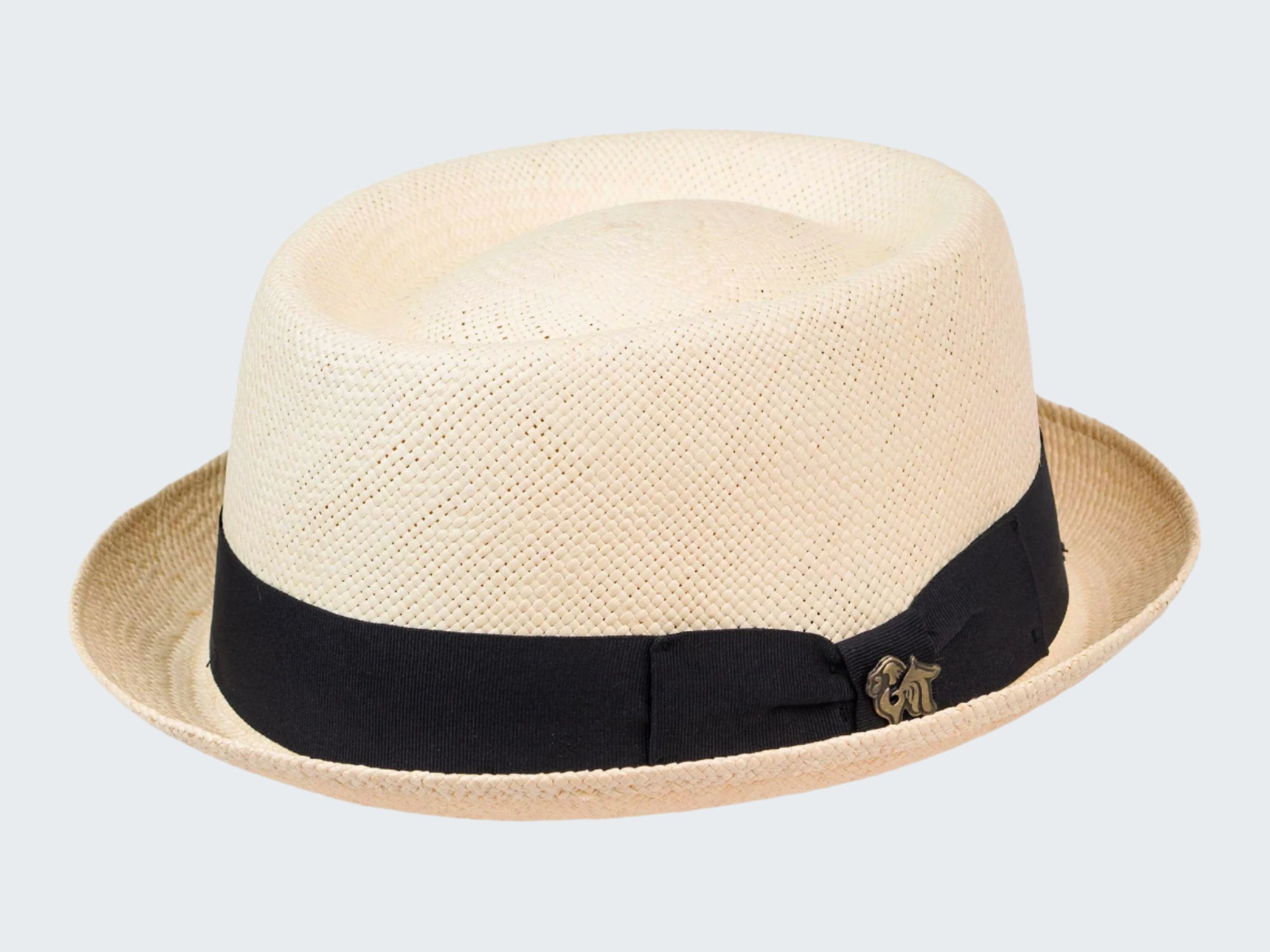 Beige straw hat with a black band and gold emblem on a white background