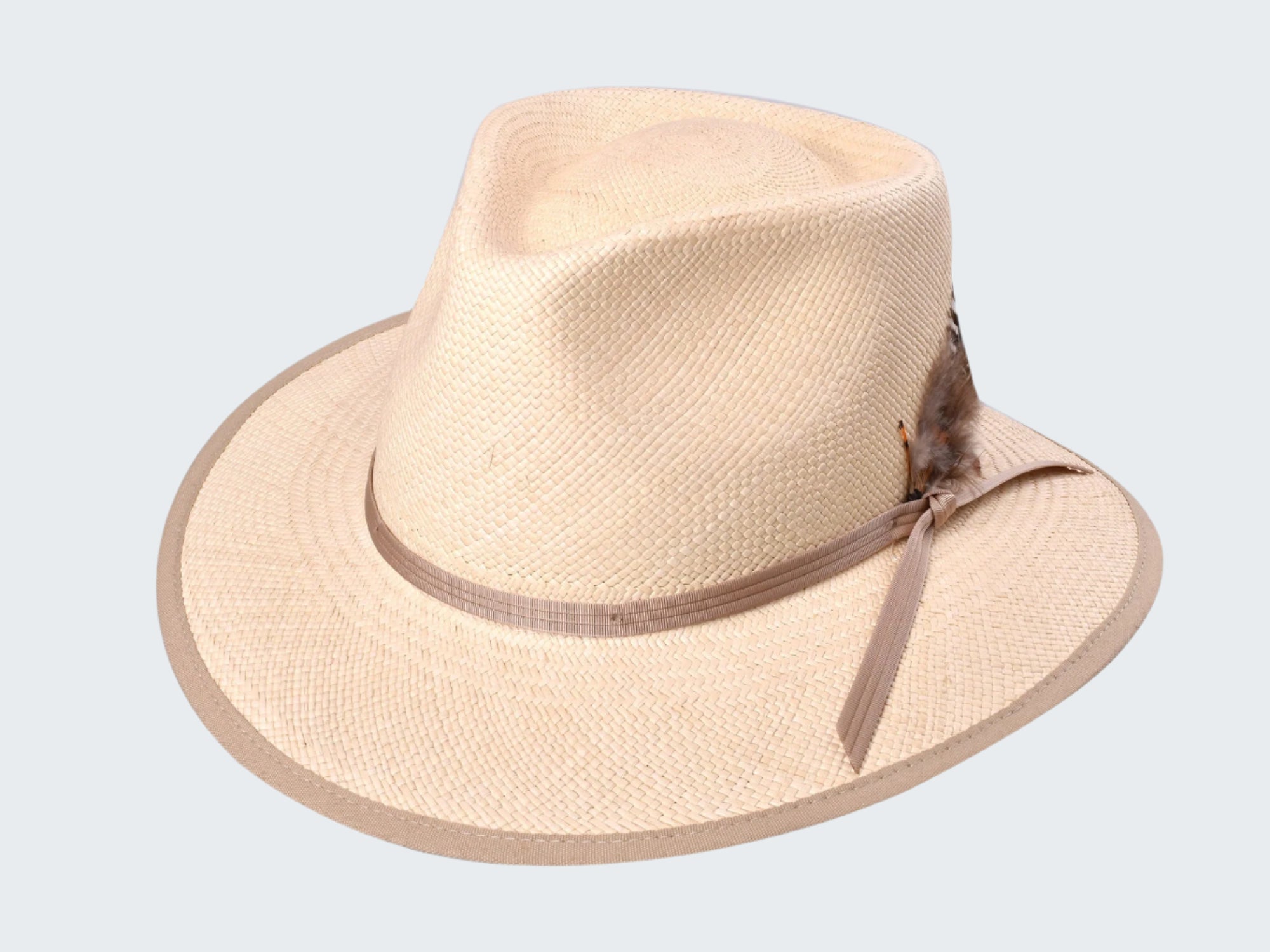 Beige straw hat with a feather on a white background