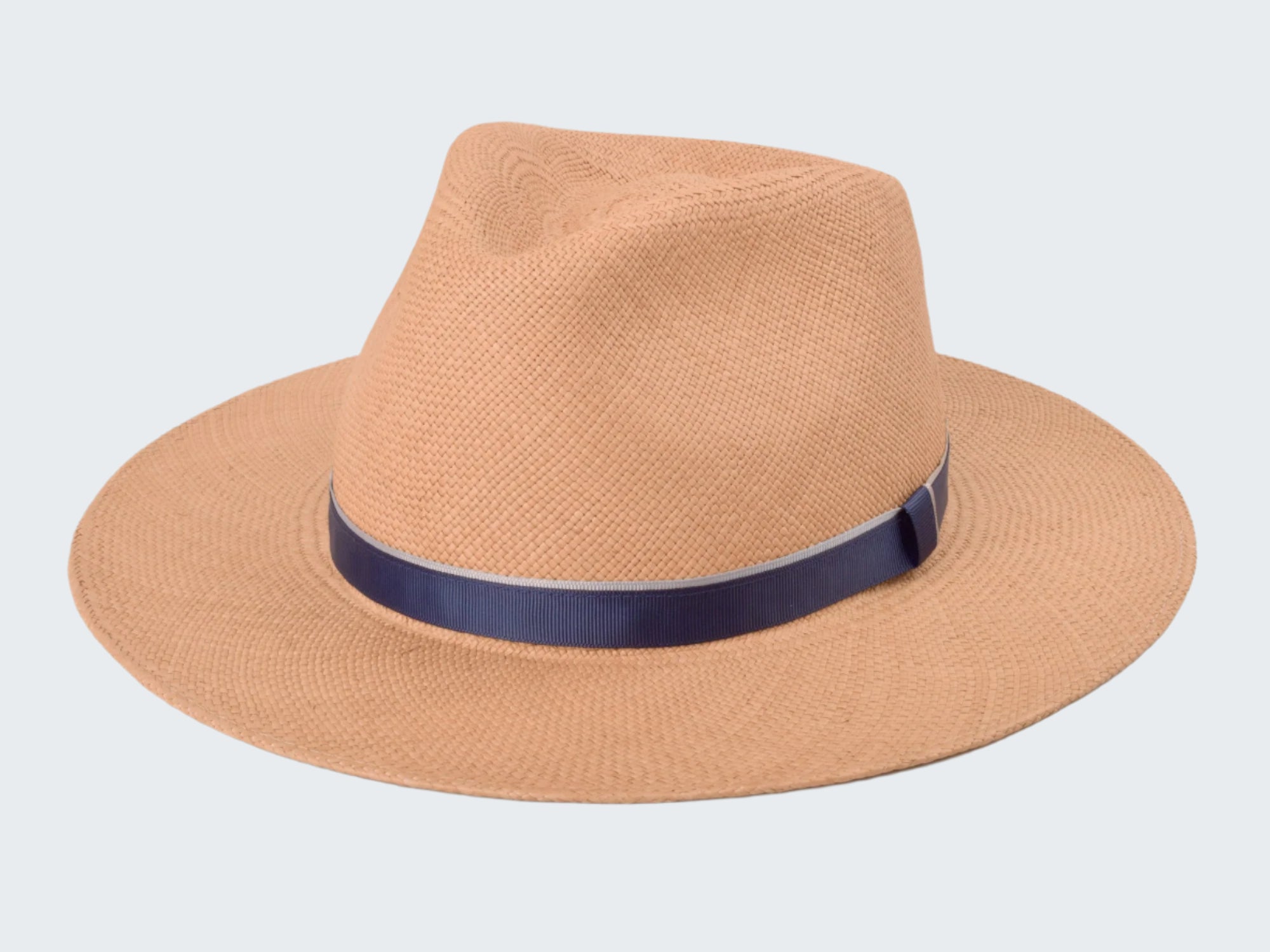 Beige straw hat with a navy band on a white background