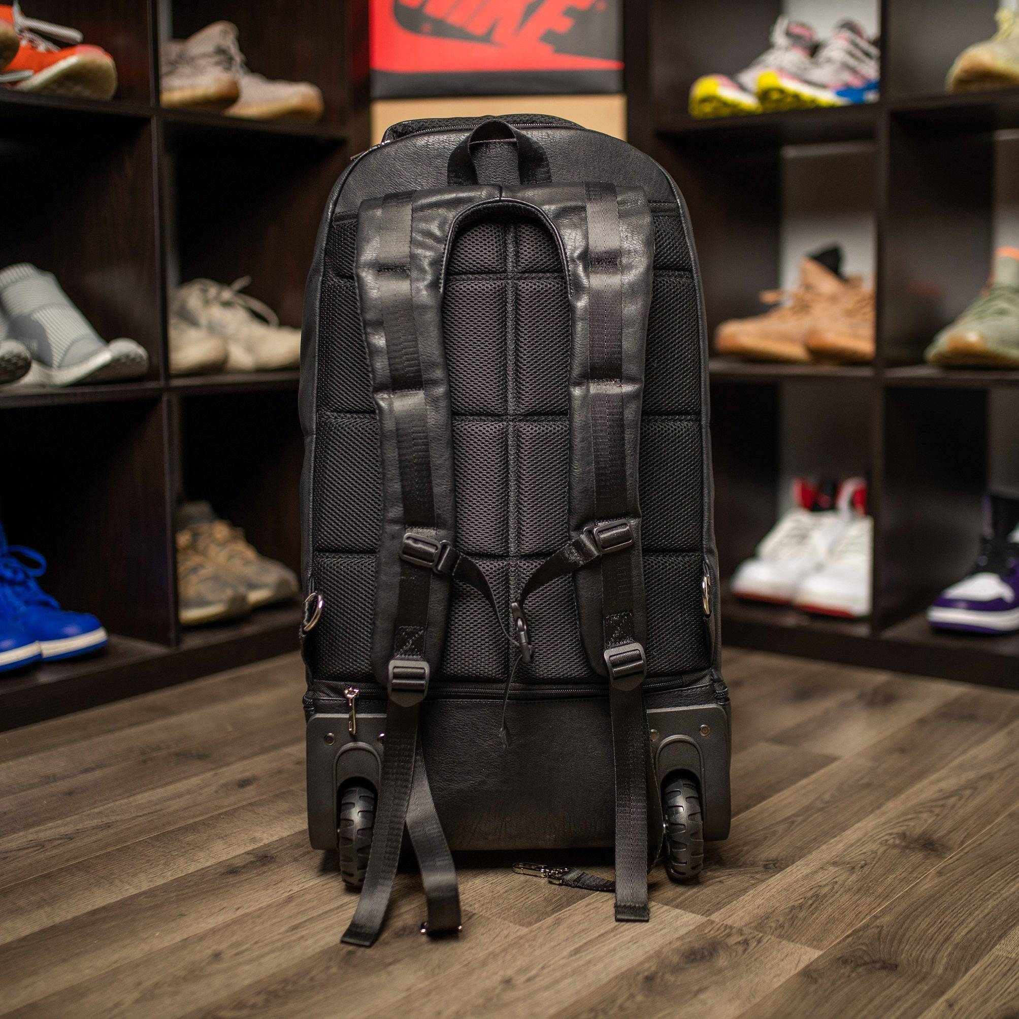 Black backpack on a wooden floor with shelves of shoes in the background