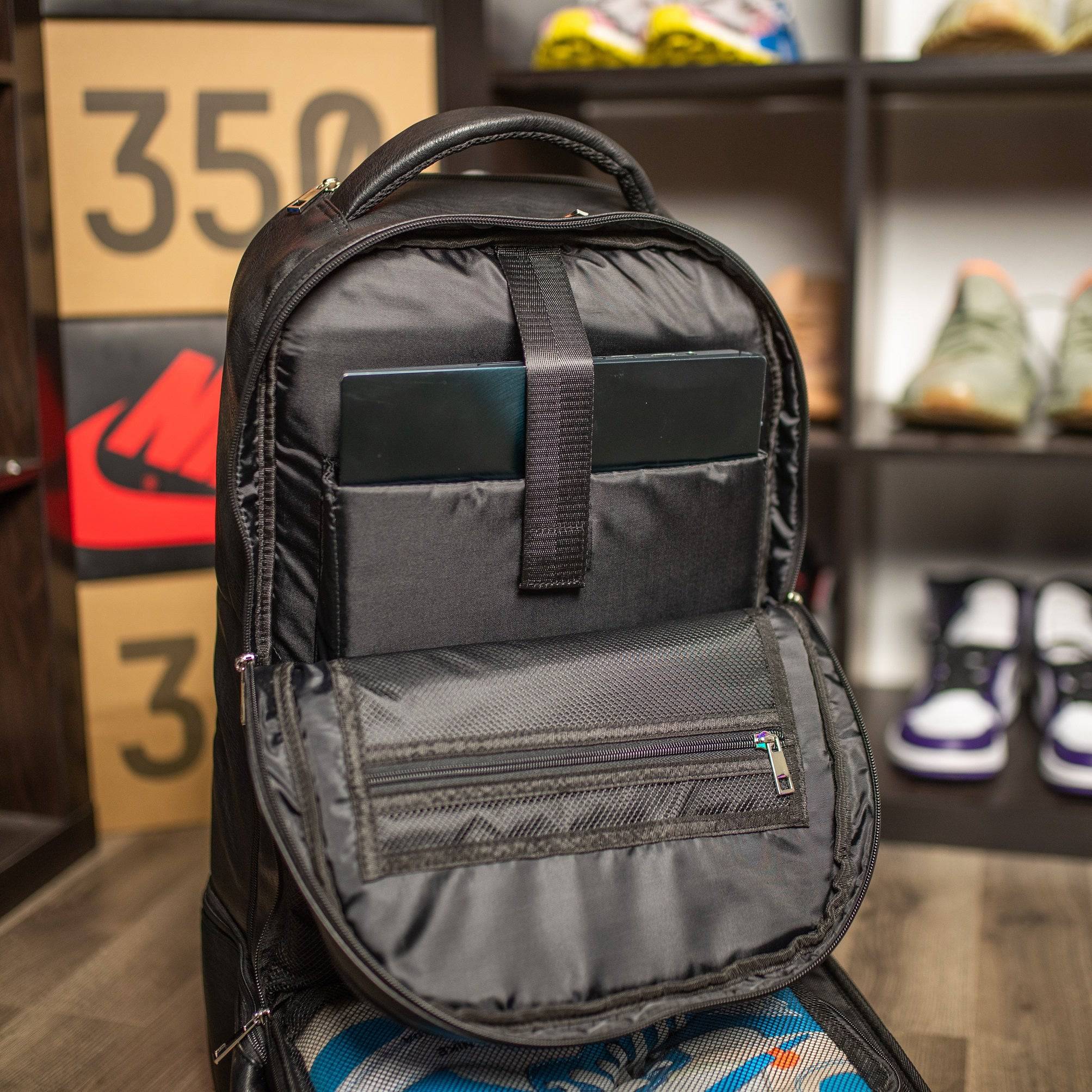 Black backpack with a laptop compartment in a store setting
