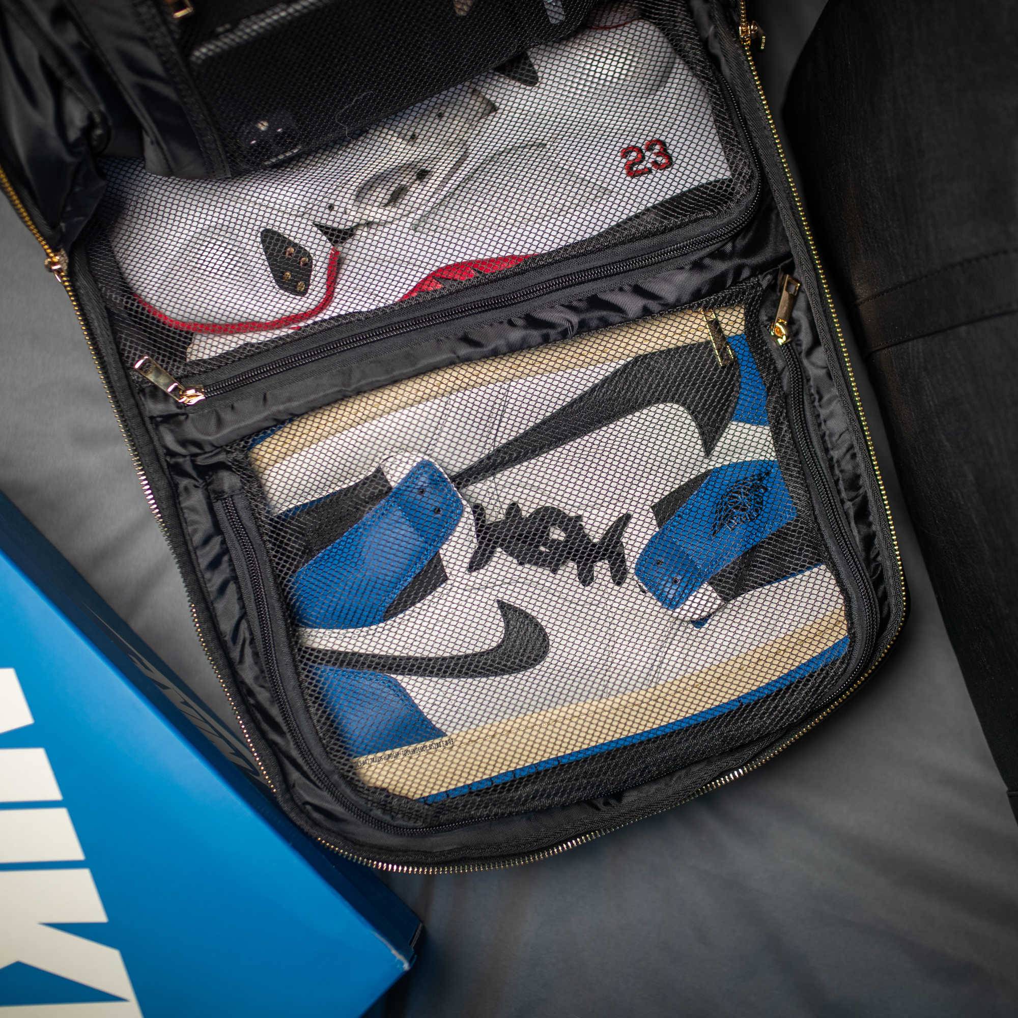 Pair of sneakers with '23' and 'YK' branding in a black sneaker bag.