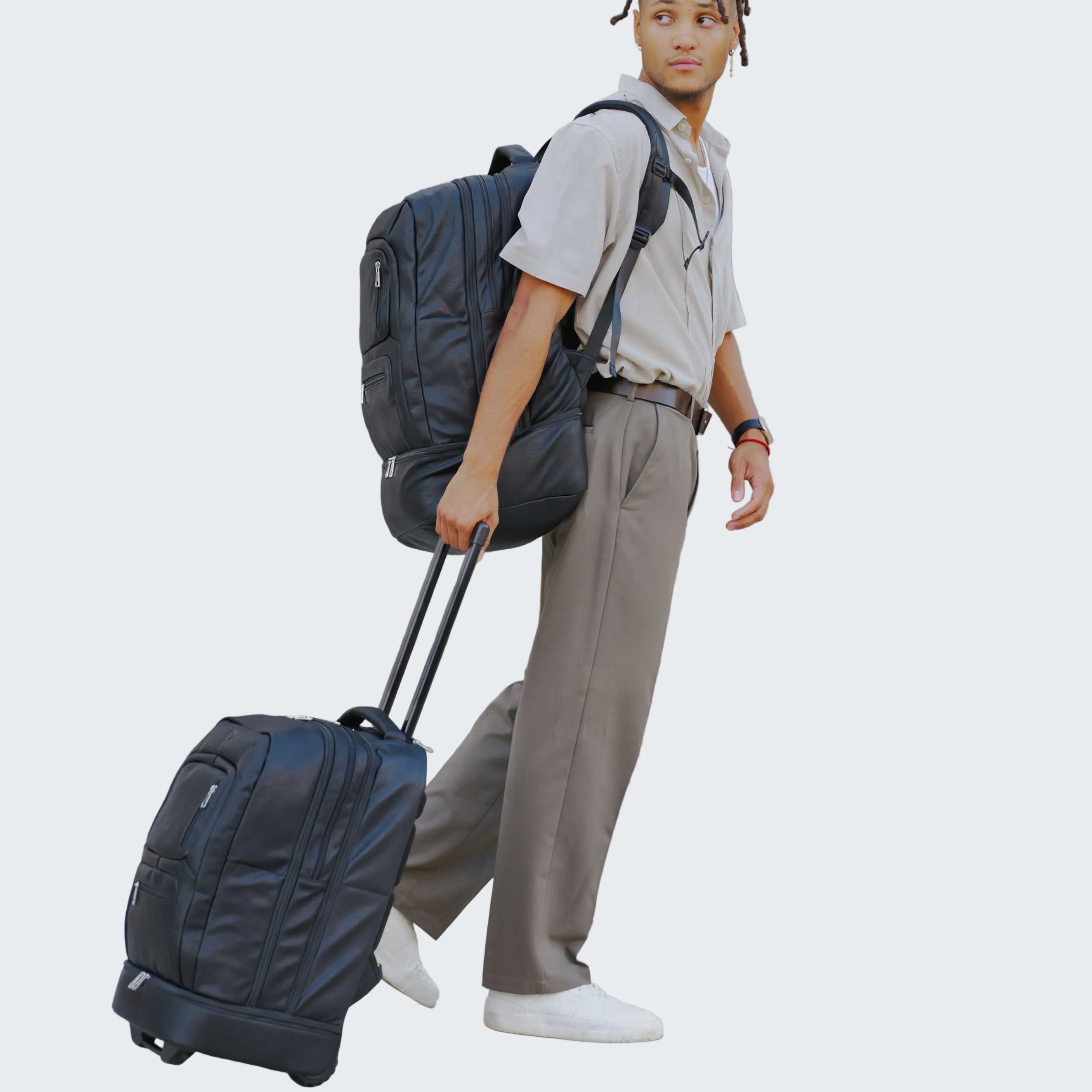 Person with a backpack and suitcase against a wooden wall.