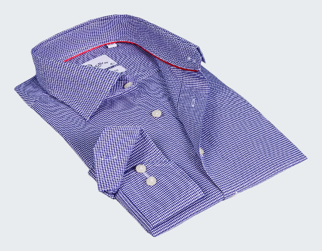 Folded blue checkered shirt with red interior on a white background