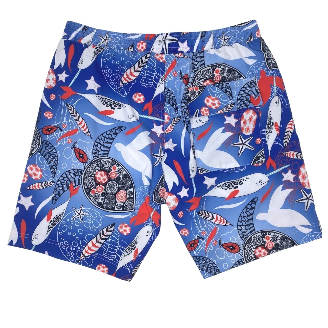Colorful swim shorts with sea-themed pattern on a white background