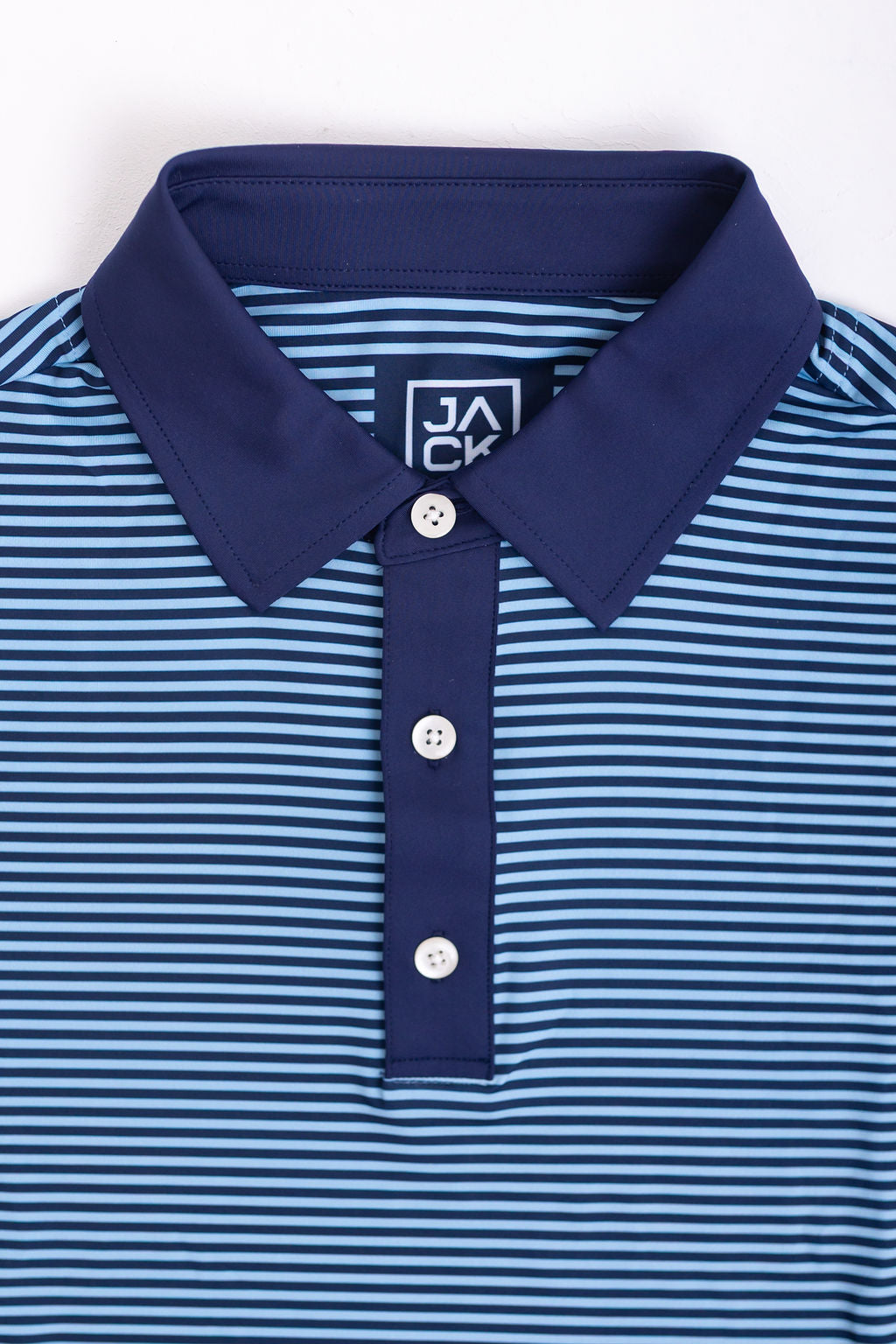 Blue and white striped polo shirt with a brand logo on a white background
