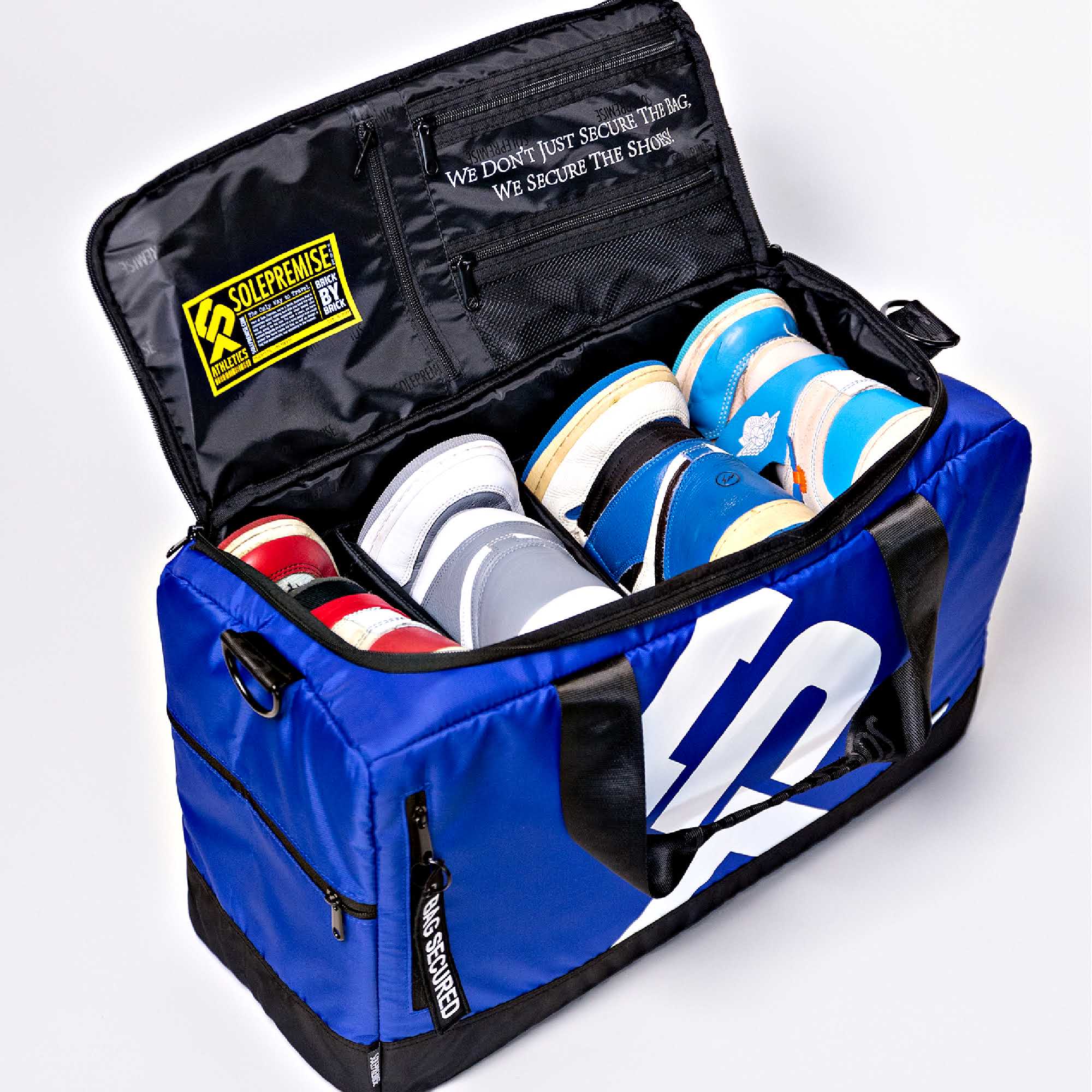 Blue duffel bag with multiple pairs of sneakers inside, featuring a visible brand logo.