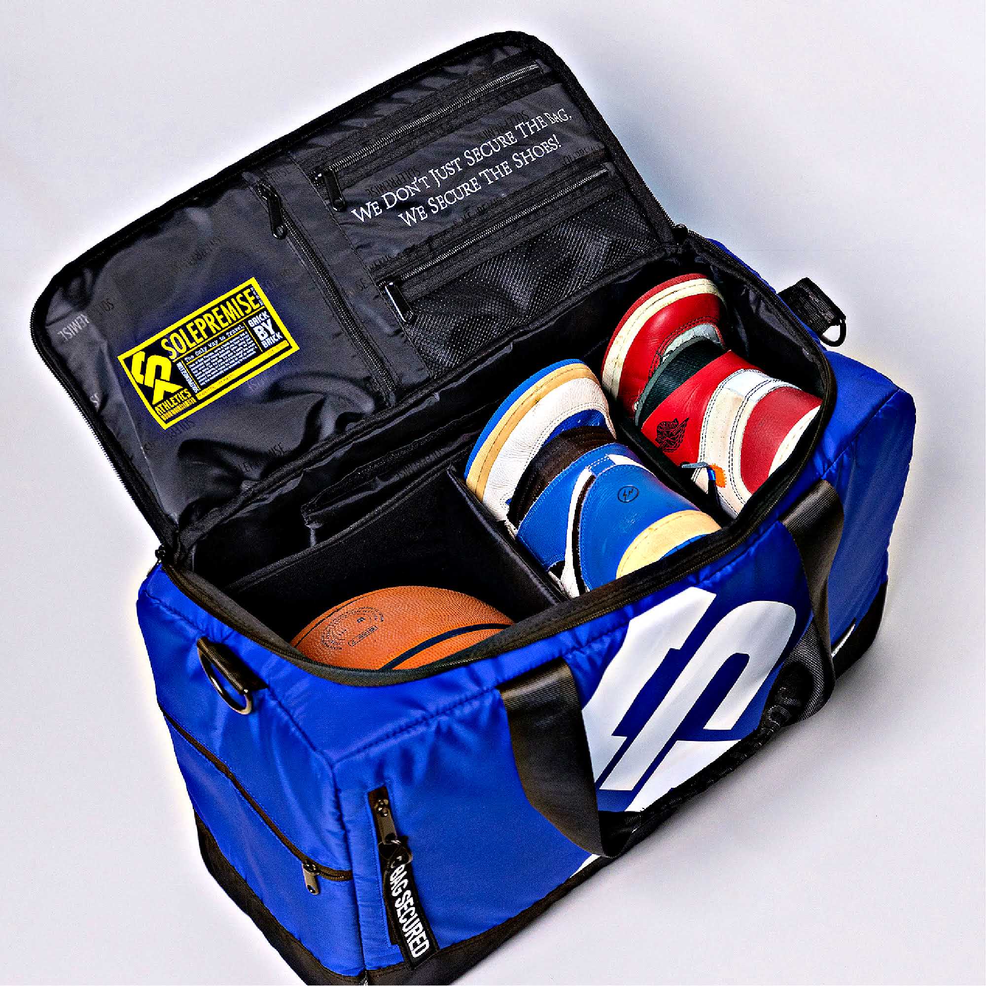 Blue sports bag with compartments for shoes and a basketball, featuring a visible brand logo.