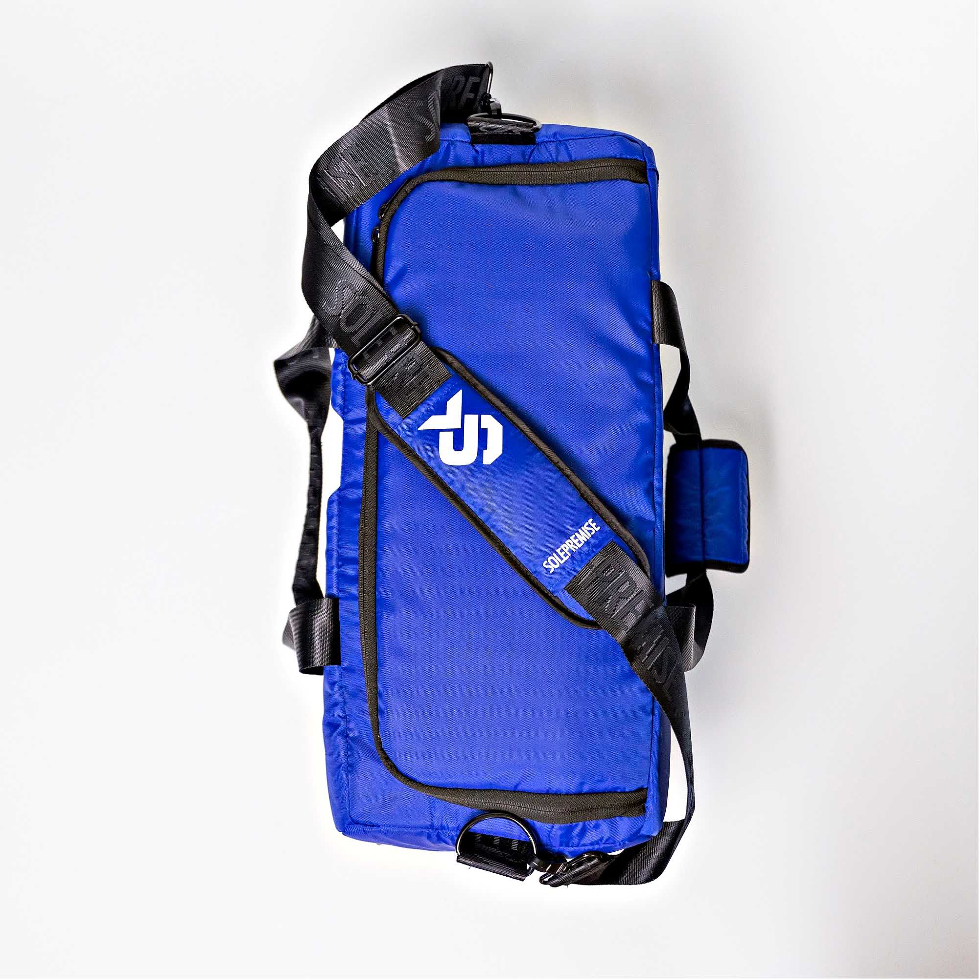 Blue hydration pack with black straps on a white background