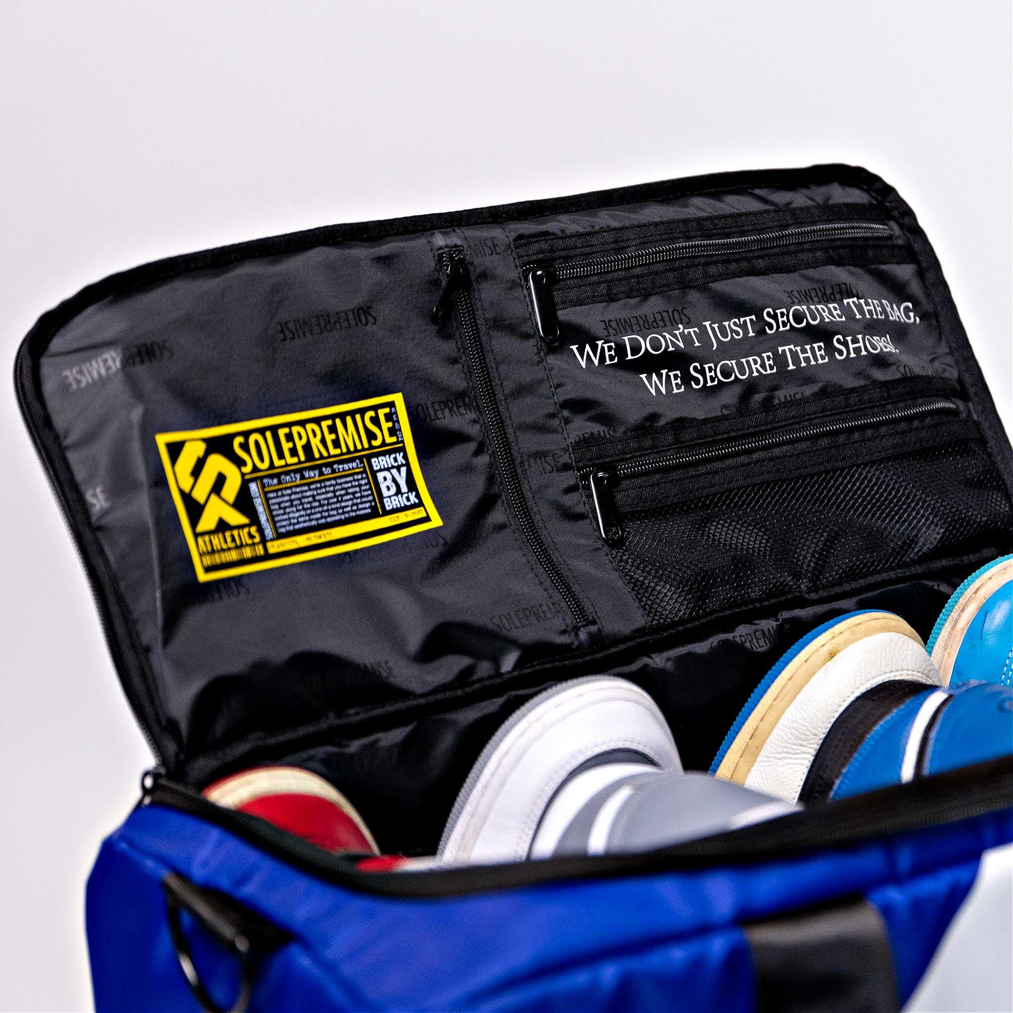 Blue shoe bag with black interior, containing shoes, and a visible Solepremise logo.