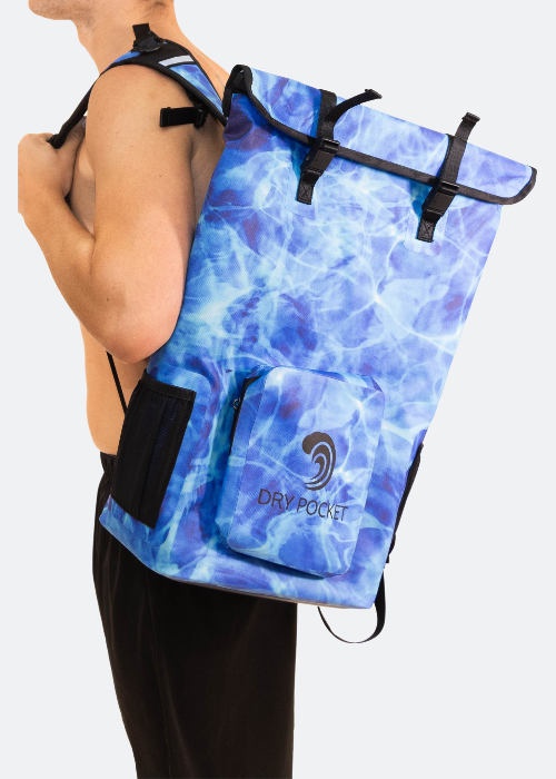 Person wearing a blue watercolor-patterned backpack with 'Dry Pocket' branding.