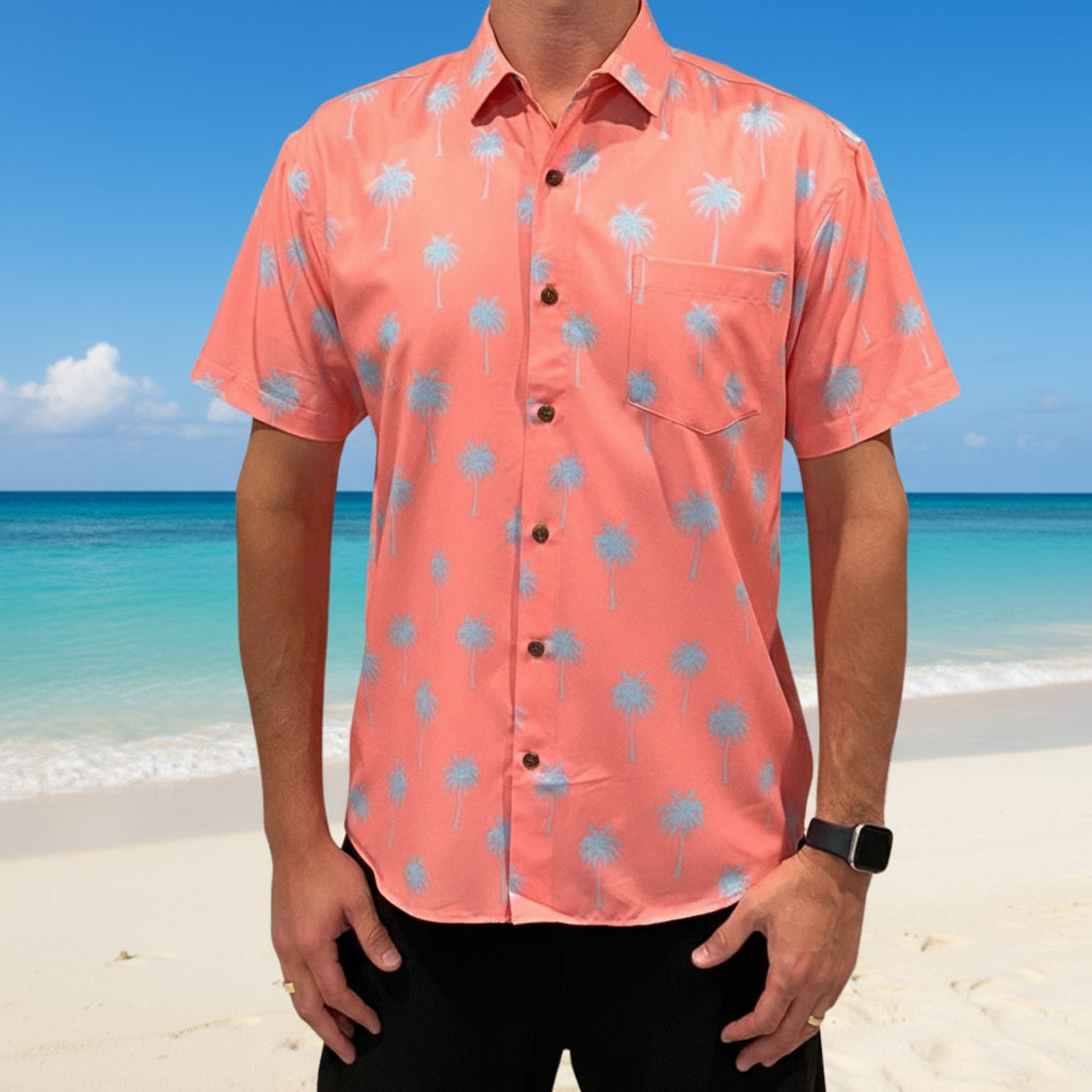 Person wearing a pink shirt with blue palm tree patterns on a white background