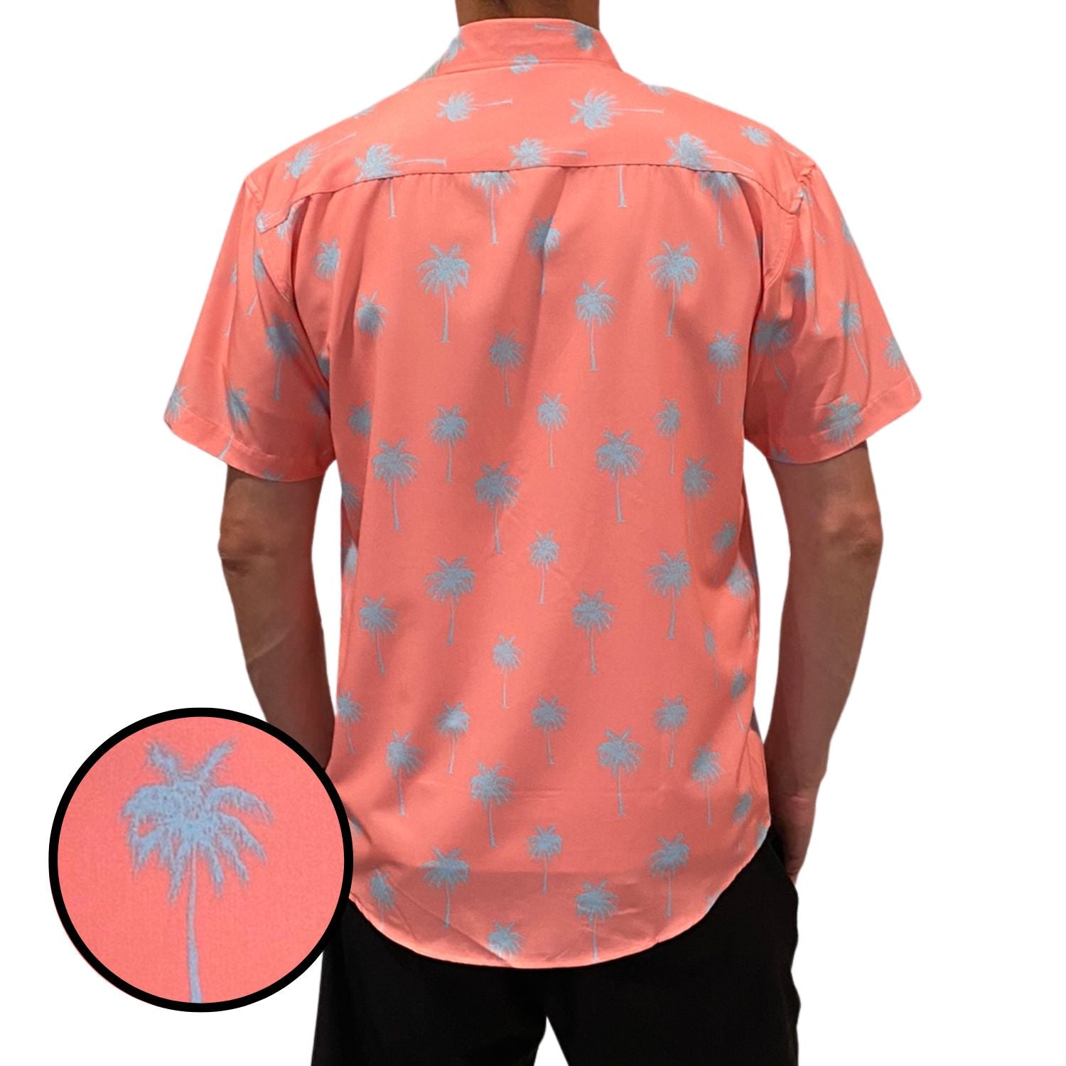 Person wearing a coral shirt with palm tree pattern, close-up of pattern shown.