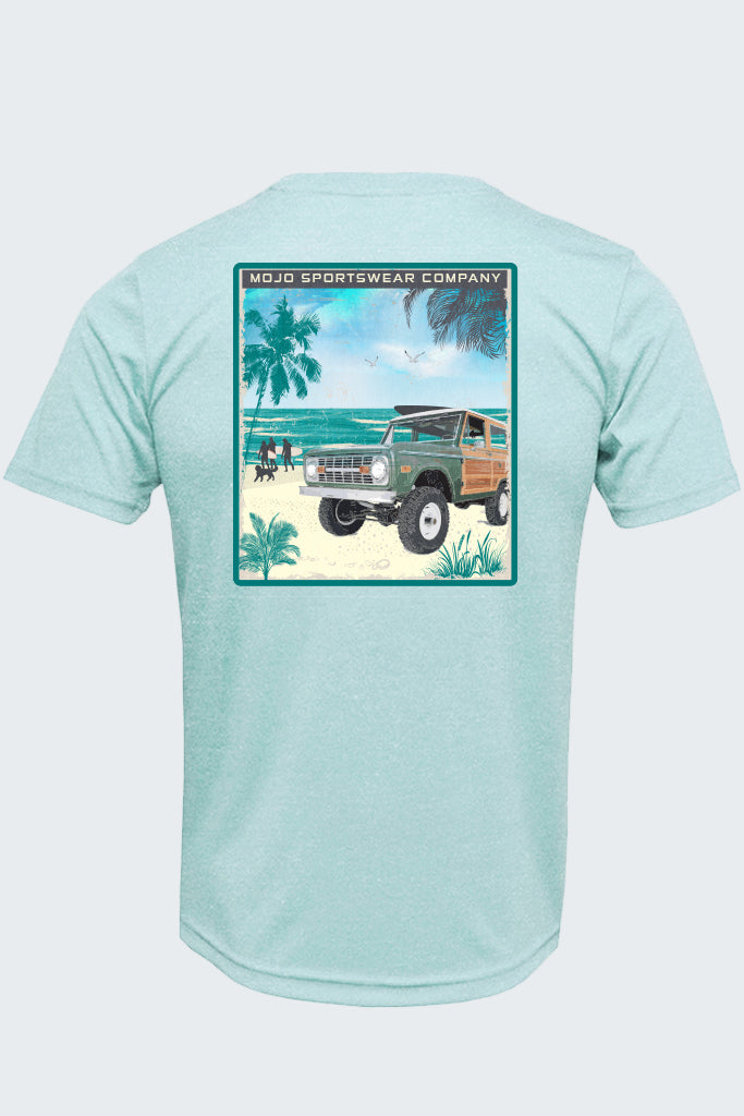 Light blue t-shirt with a graphic of a beach scene and vintage truck on a white background