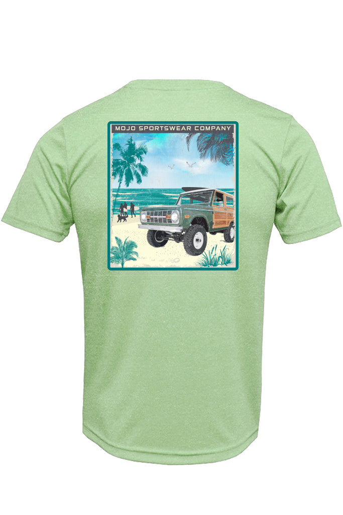 Green t-shirt with a graphic of a beach scene and vintage truck on the back, brand 'Mojo Sportswear Company' visible.