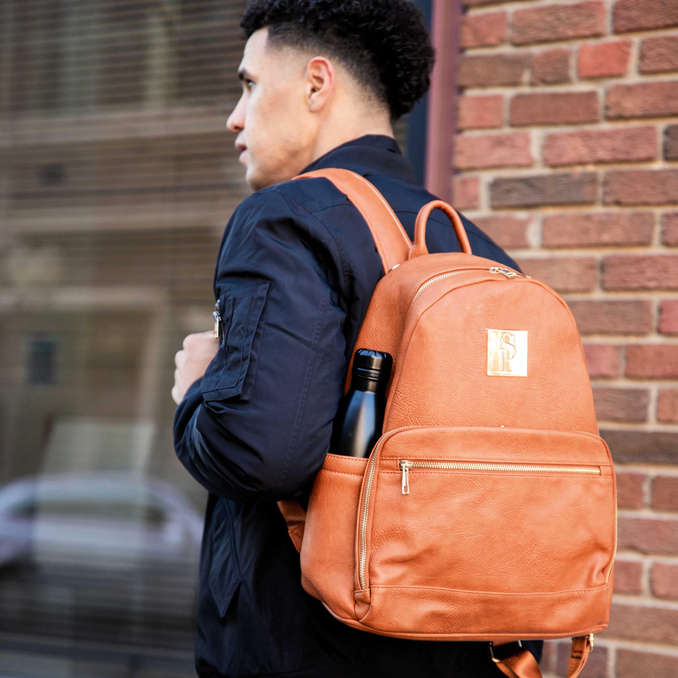 Person wearing a brown leather backpack with a blurred background