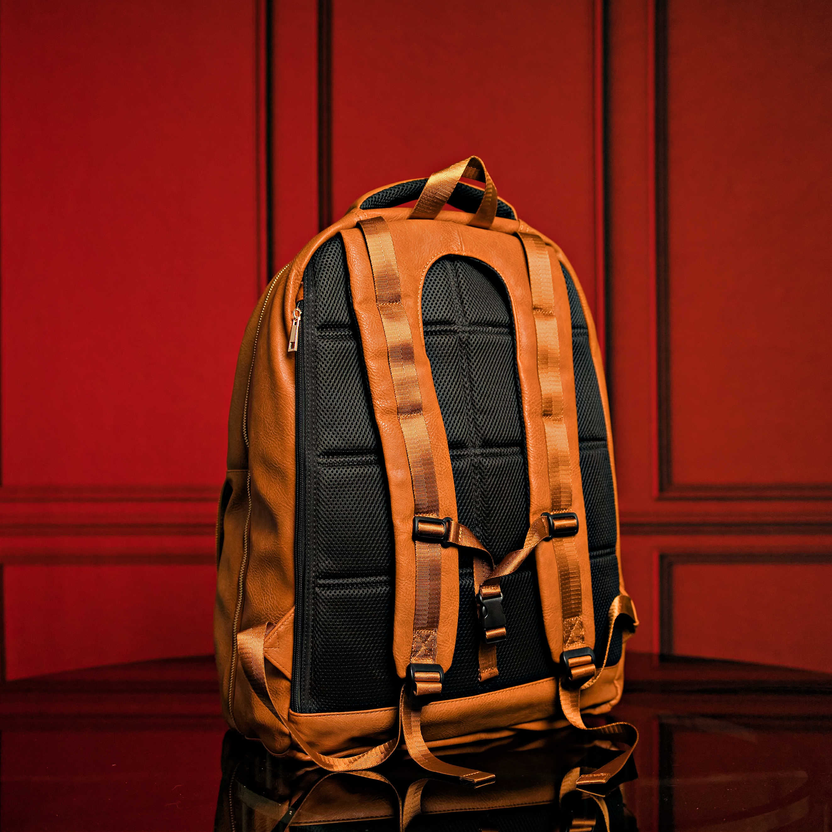 Brown backpack on a red background