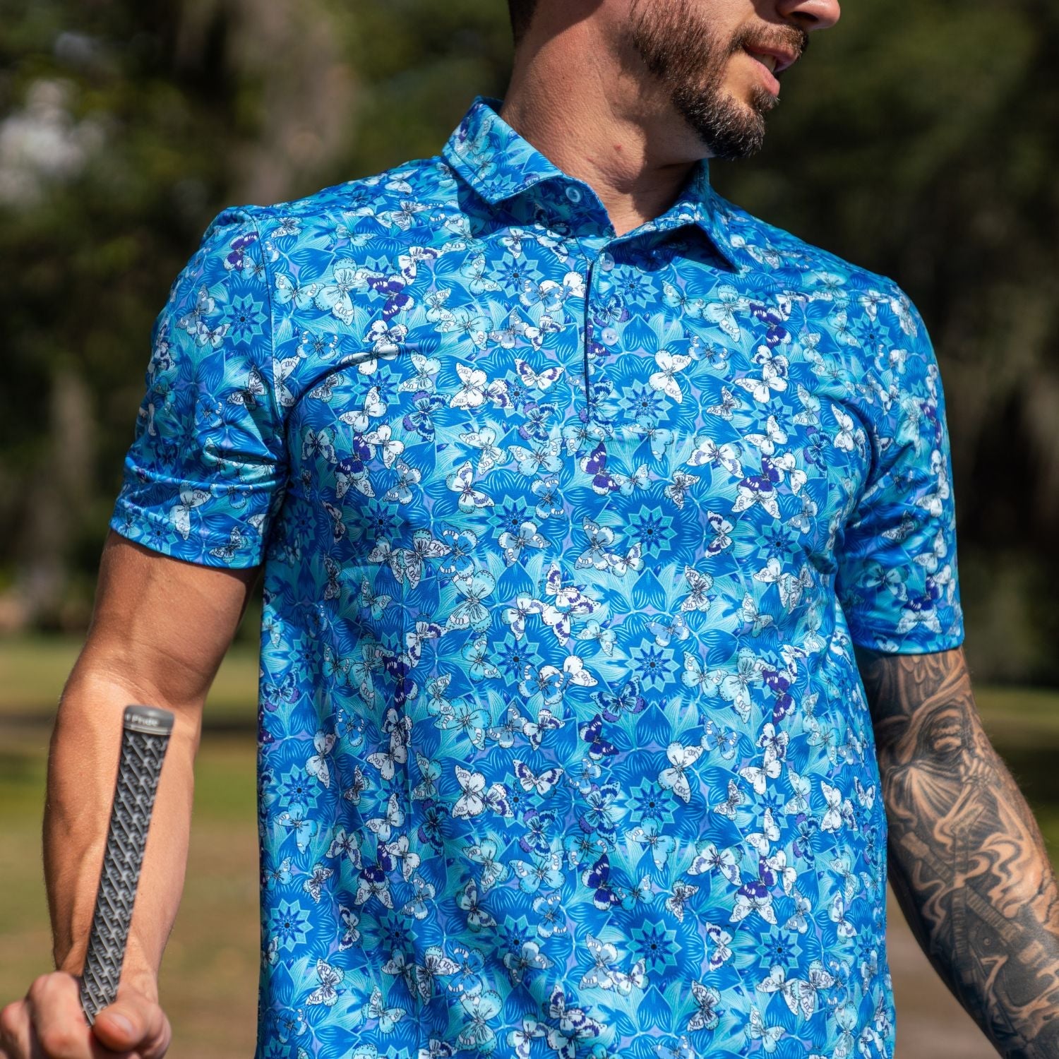 Man wearing a blue floral patterned shirt outdoors