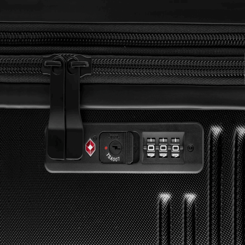 Close-up of a black suitcase with a lock and brand logo.