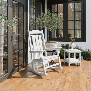 White rocking chair on a wooden deck with a house in the background