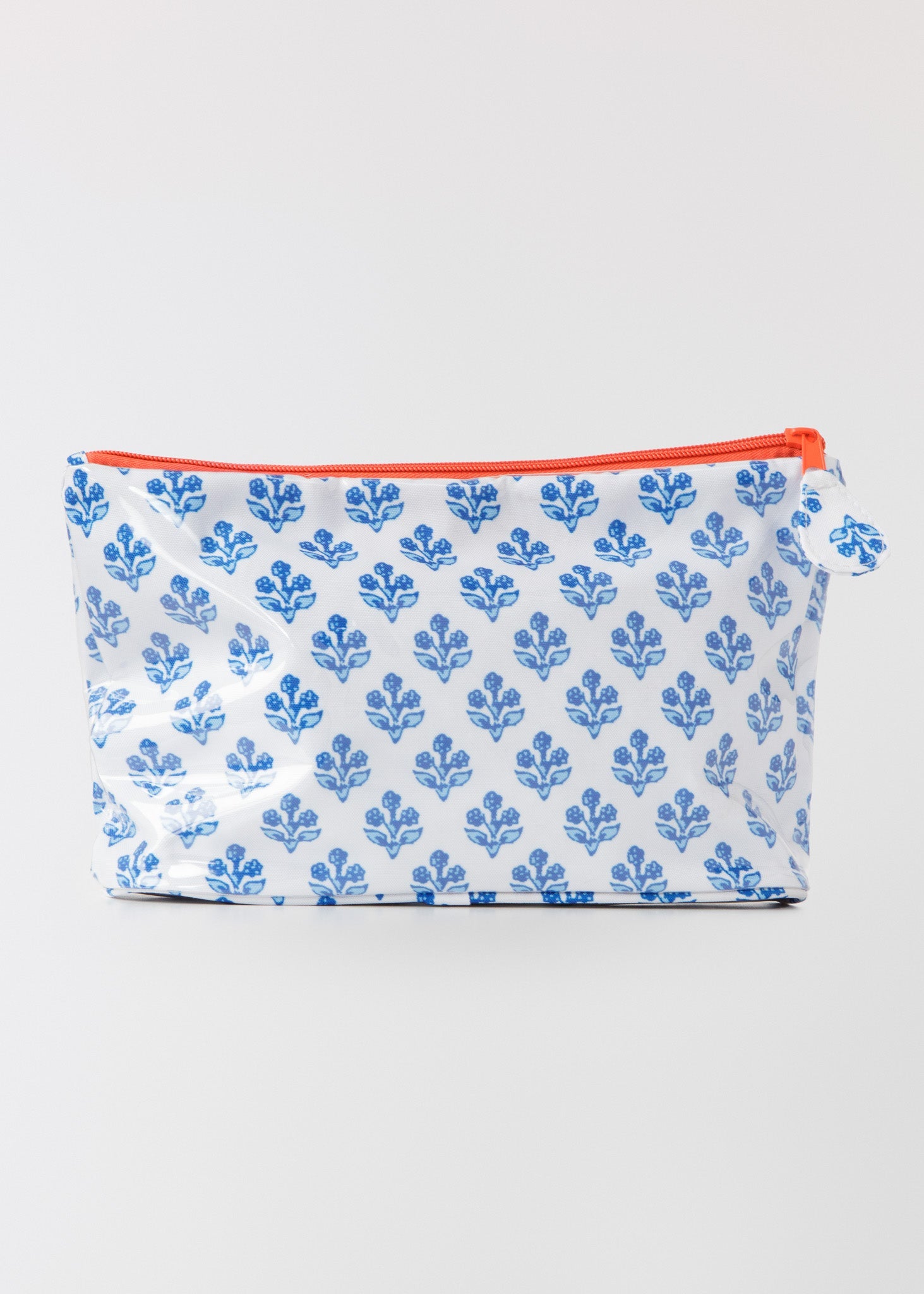 Pouch with blue floral pattern and red zipper on a white background