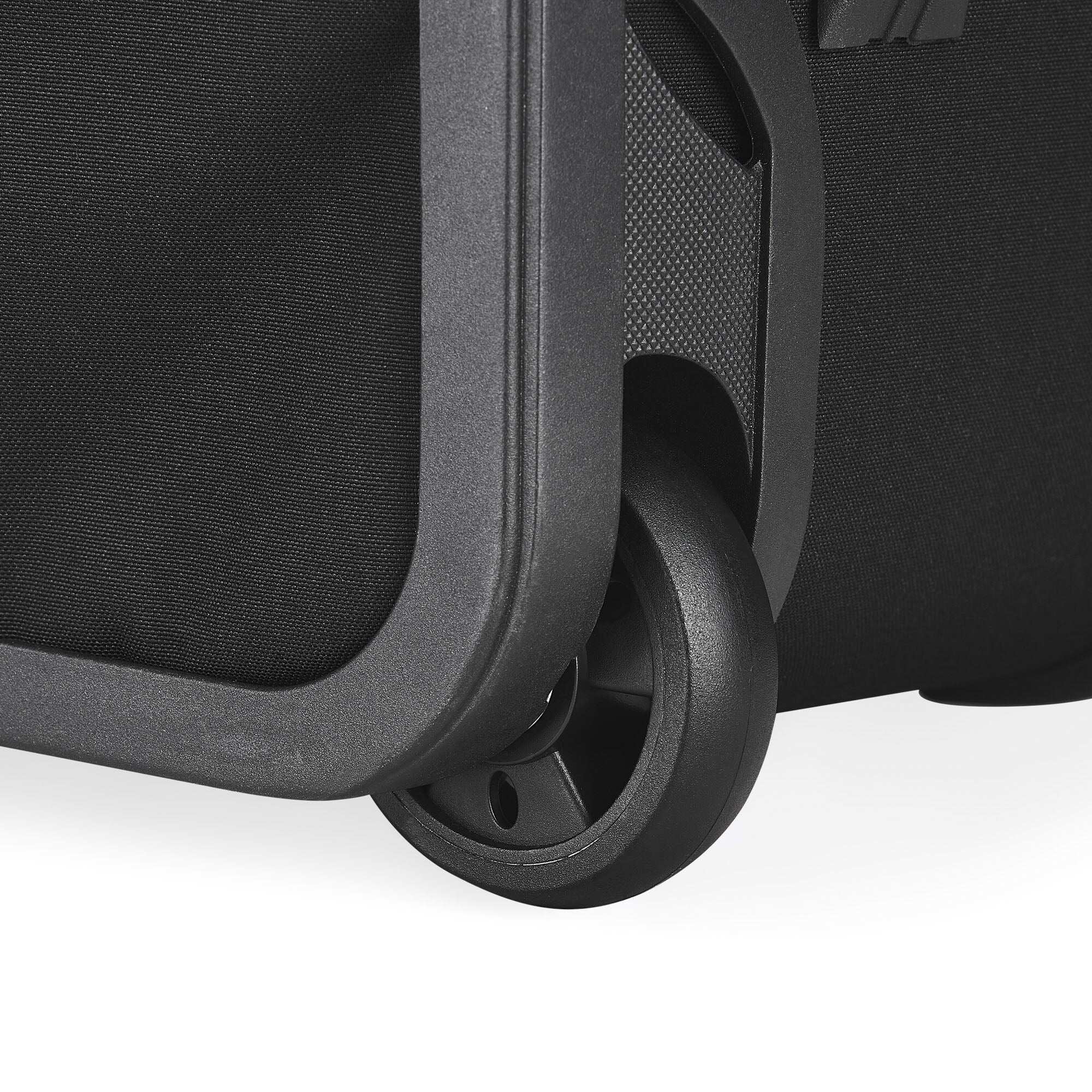 Close-up of a black suitcase wheel on a white background