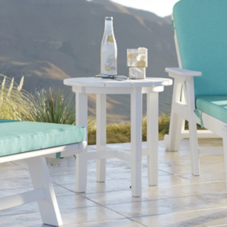 Outdoor furniture set with white table and chairs on a wooden deck, featuring a bottle and small container.