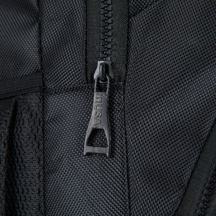 Close-up of a black zipper on a textured black surface