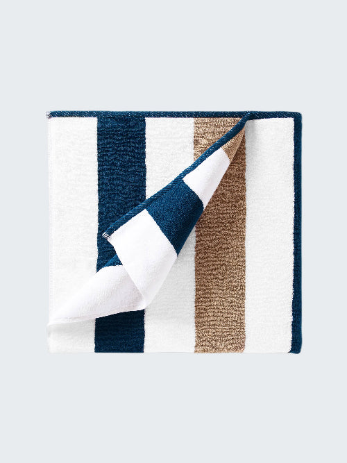 Folded fabric with blue, white, and brown stripes on a white background