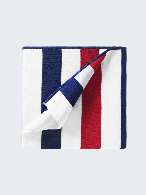 Folded towel with red, white, and blue stripes on a white background