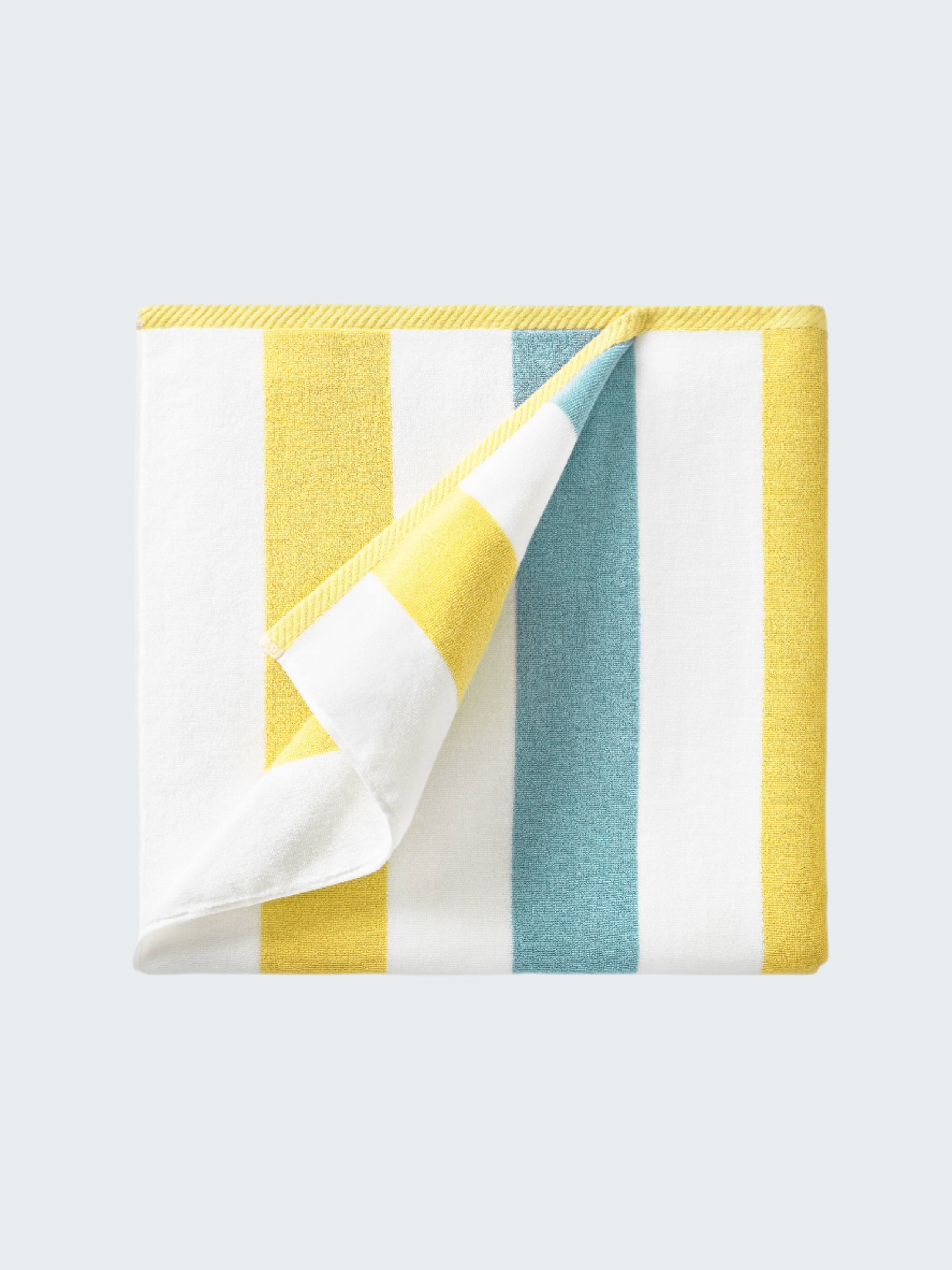 Colorful striped fabric with yellow, white, and blue stripes on a white background