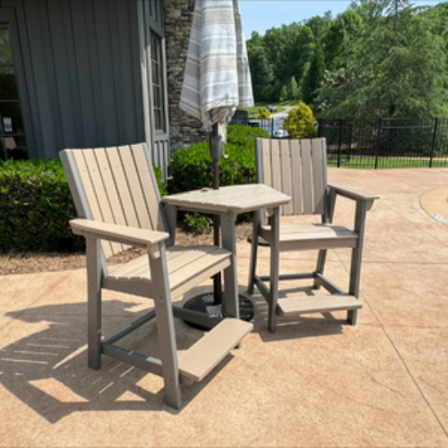 Outdoor patio set with two chairs and a table on a concrete patio.