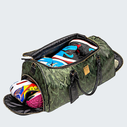 Camouflage duffel bag with colorful shoes inside on a light gray background