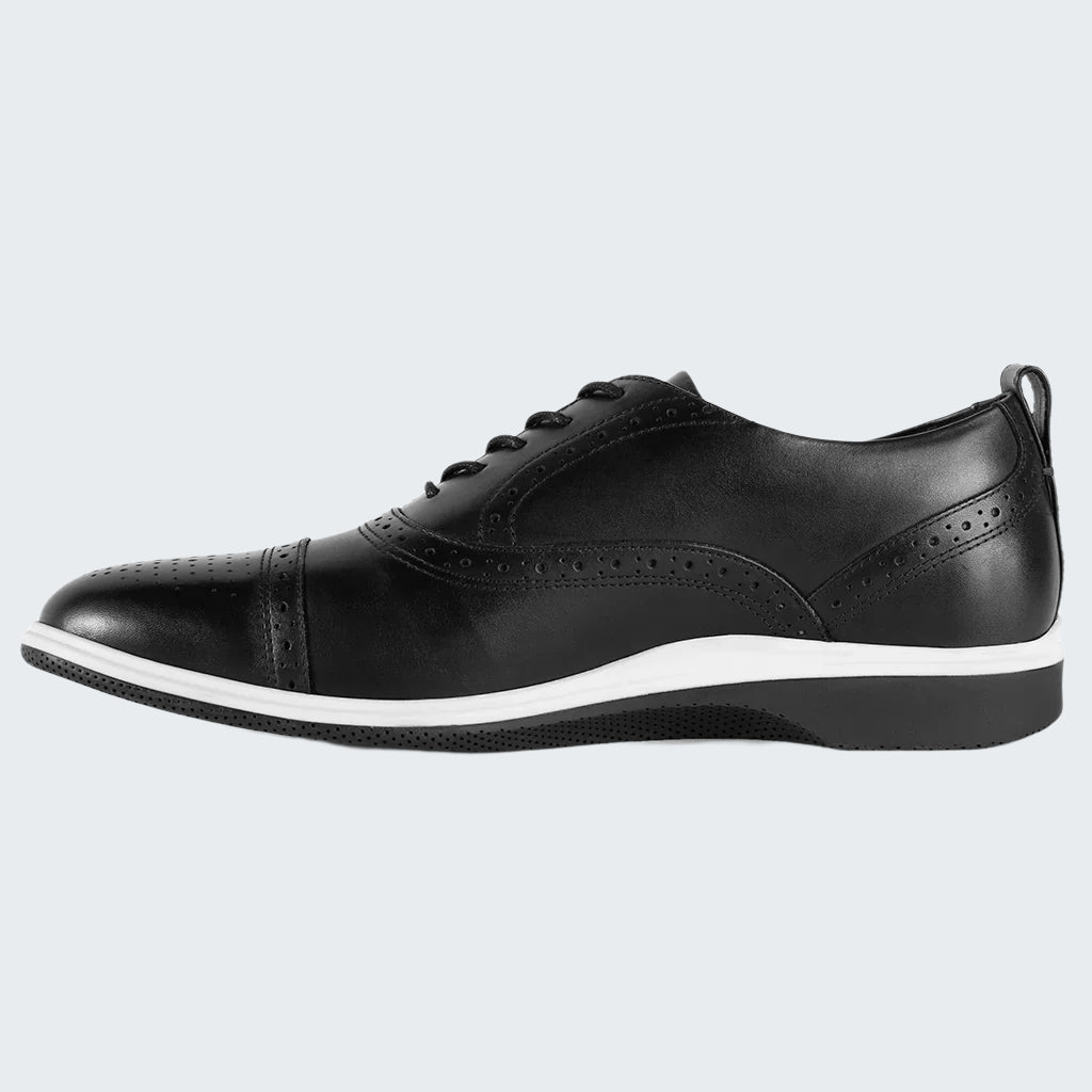 Black leather shoe with white sole on a white background